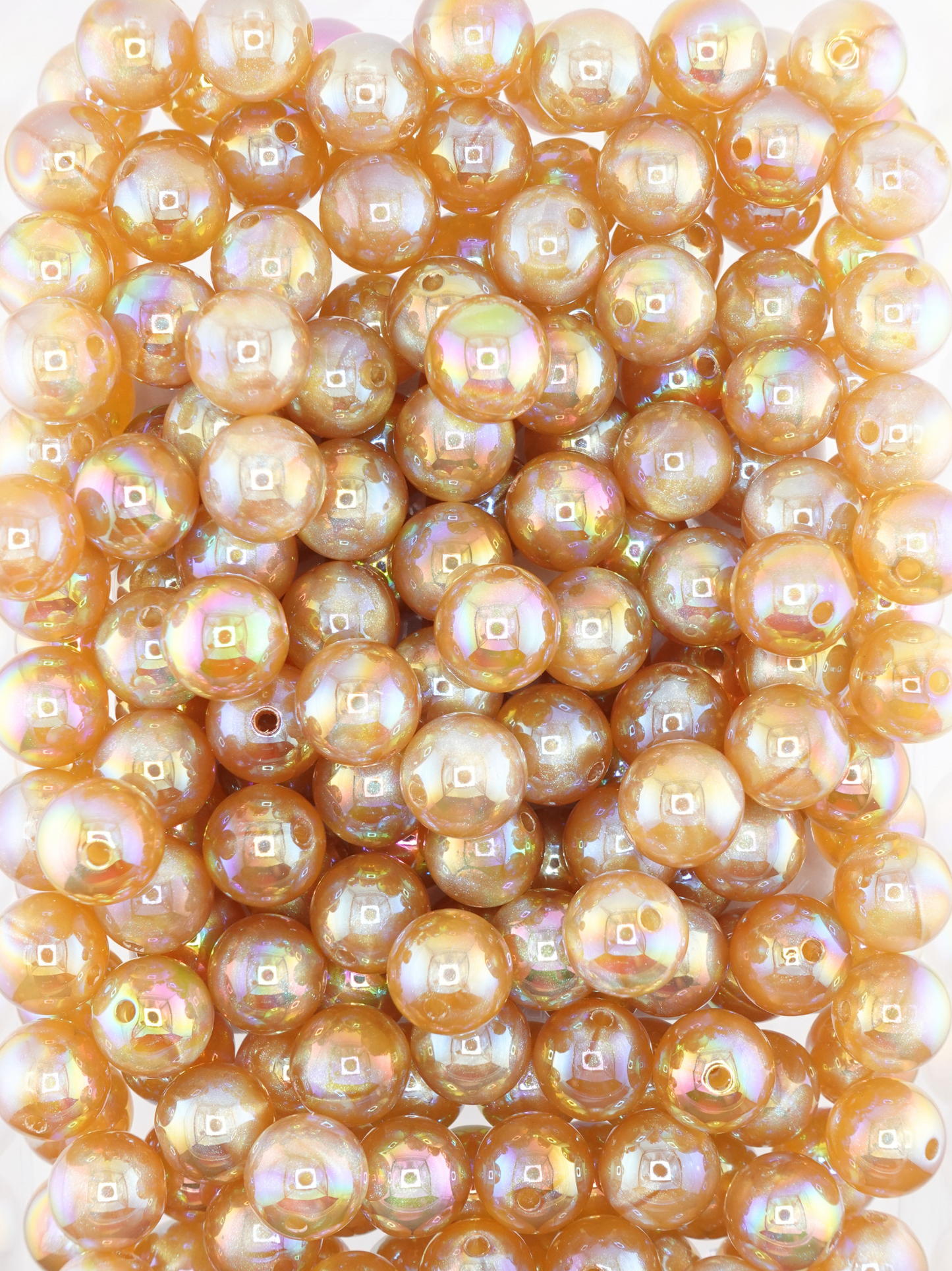 Collection of champagne colored beads with an aurora borealis and galaxy shimmer