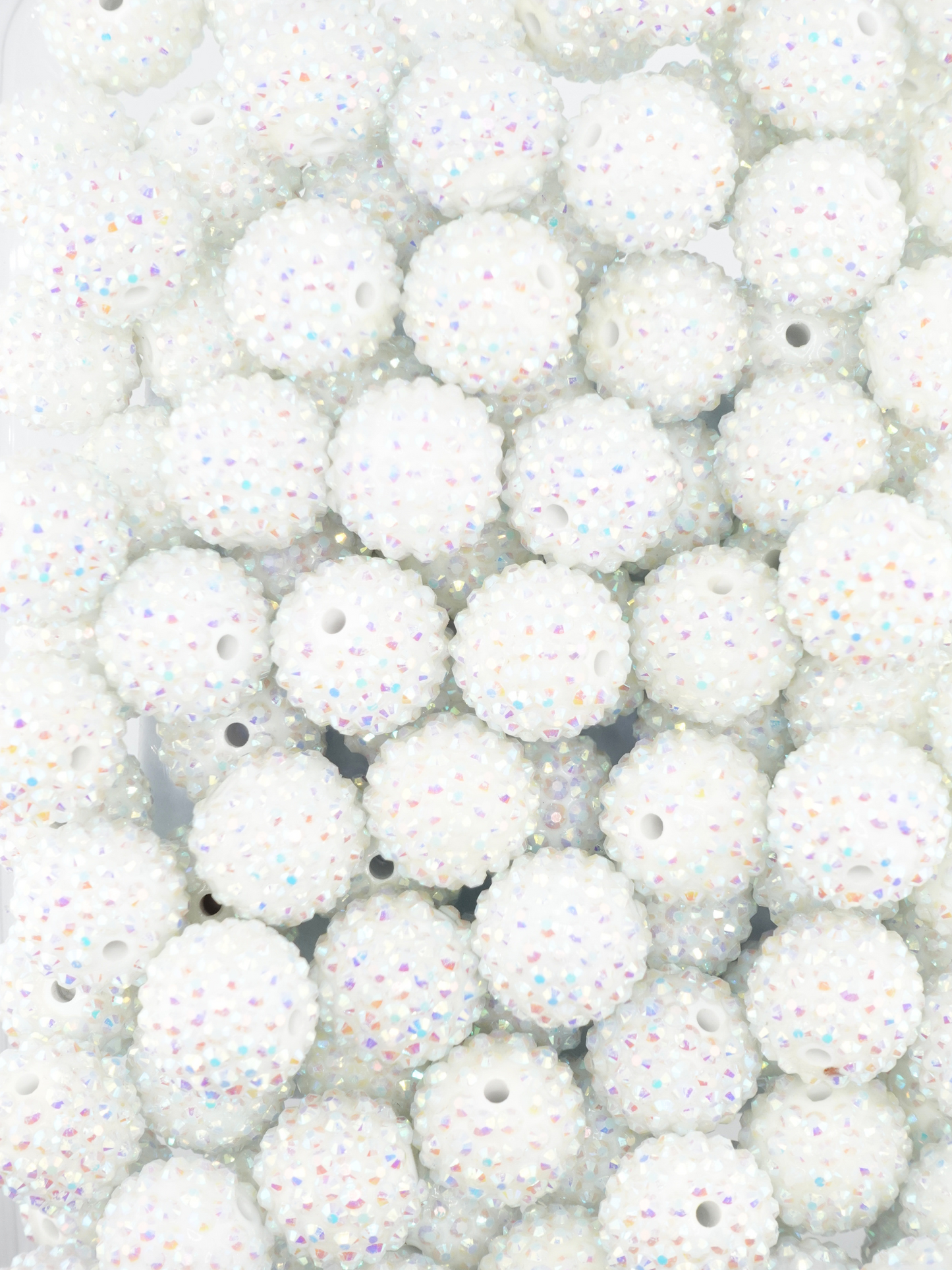 Collection of white beads with a rhinestone texture