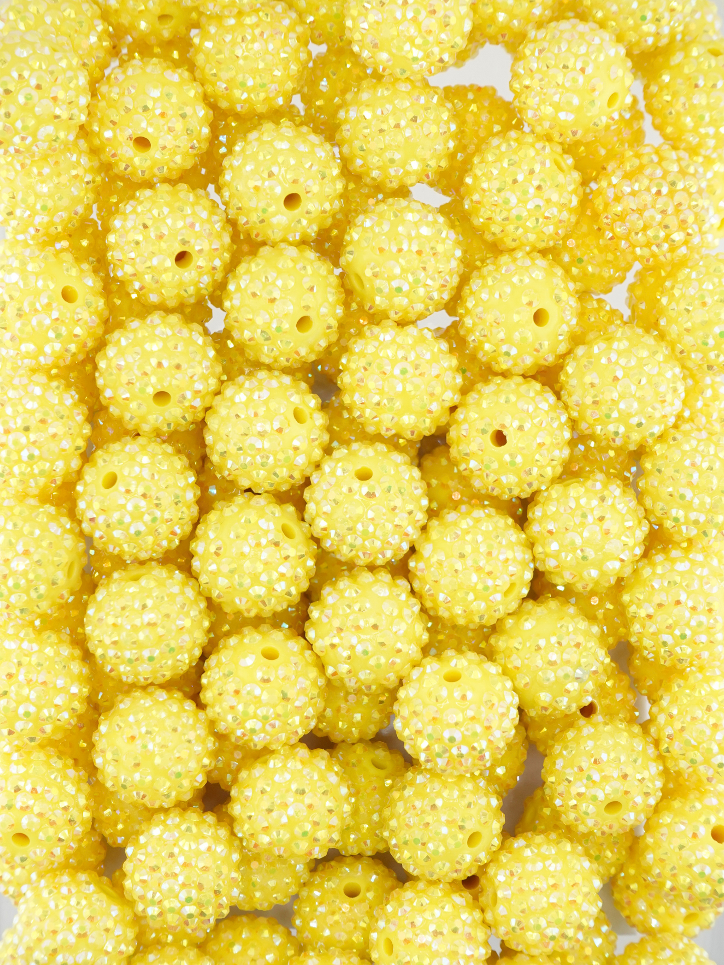 Collection of yellow beads with a rhinestone texture