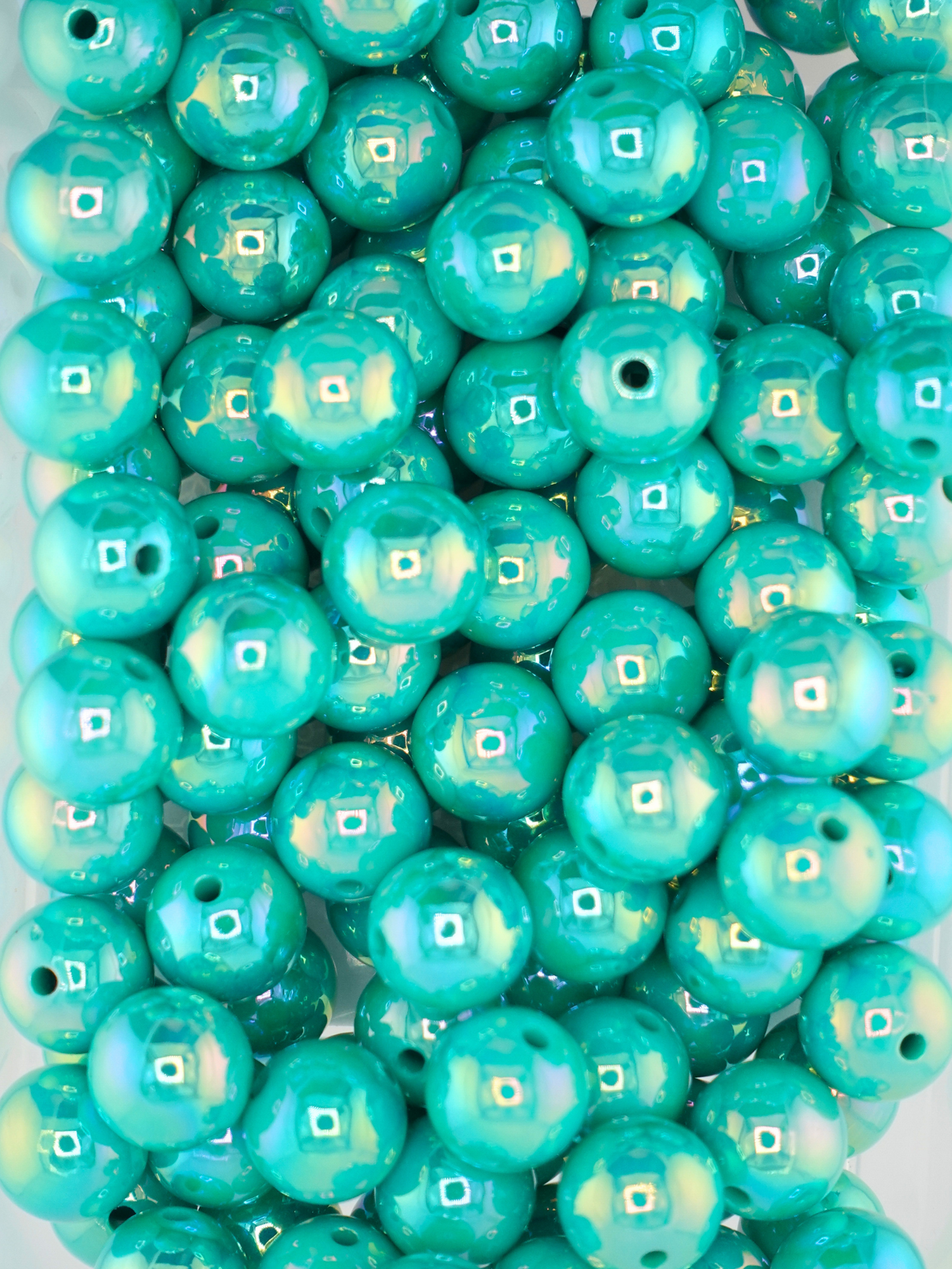 Collection of teal colored beads with an aurora borealis finish