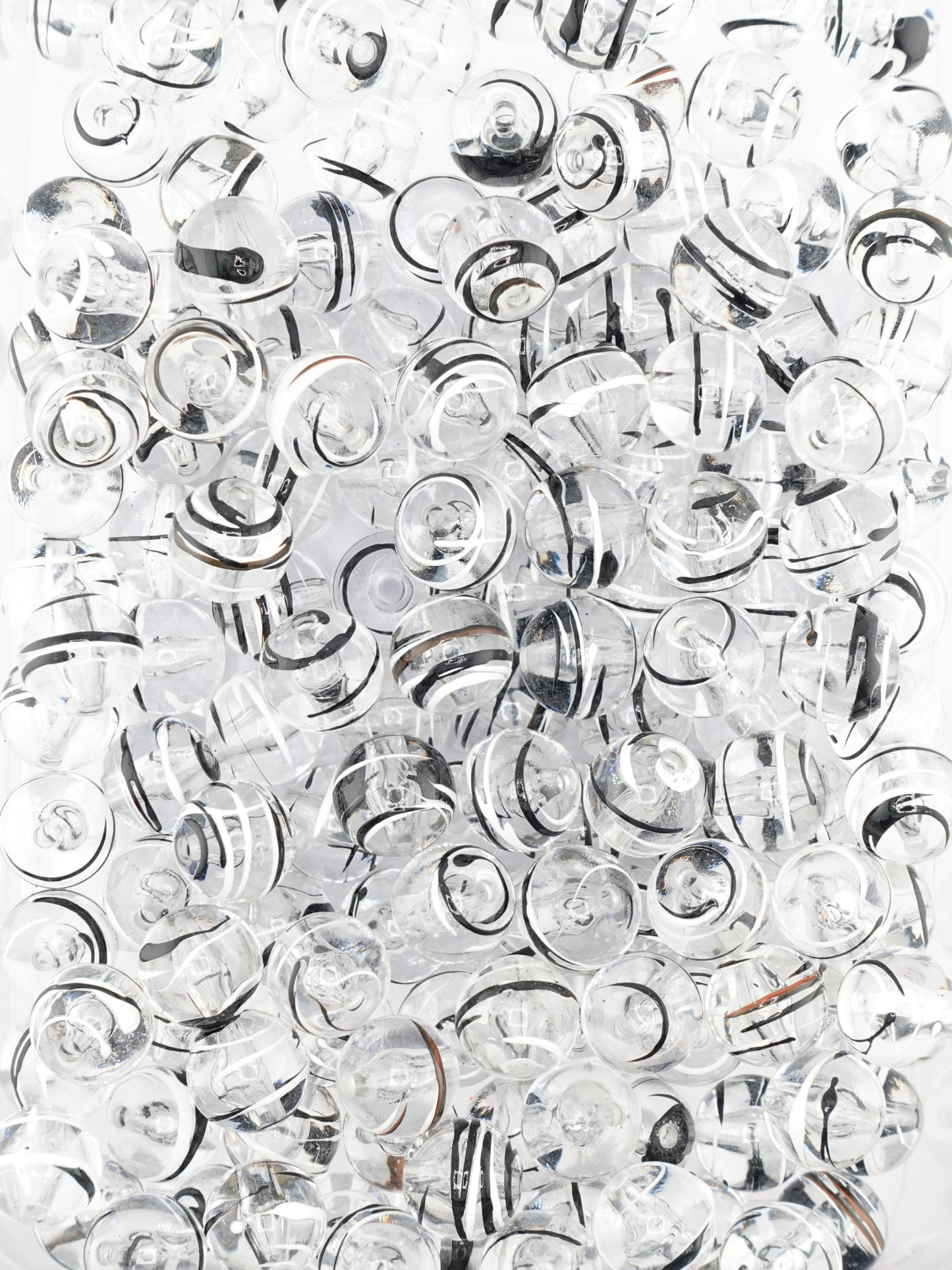Collection of clear beads with a black & white paint stroke design