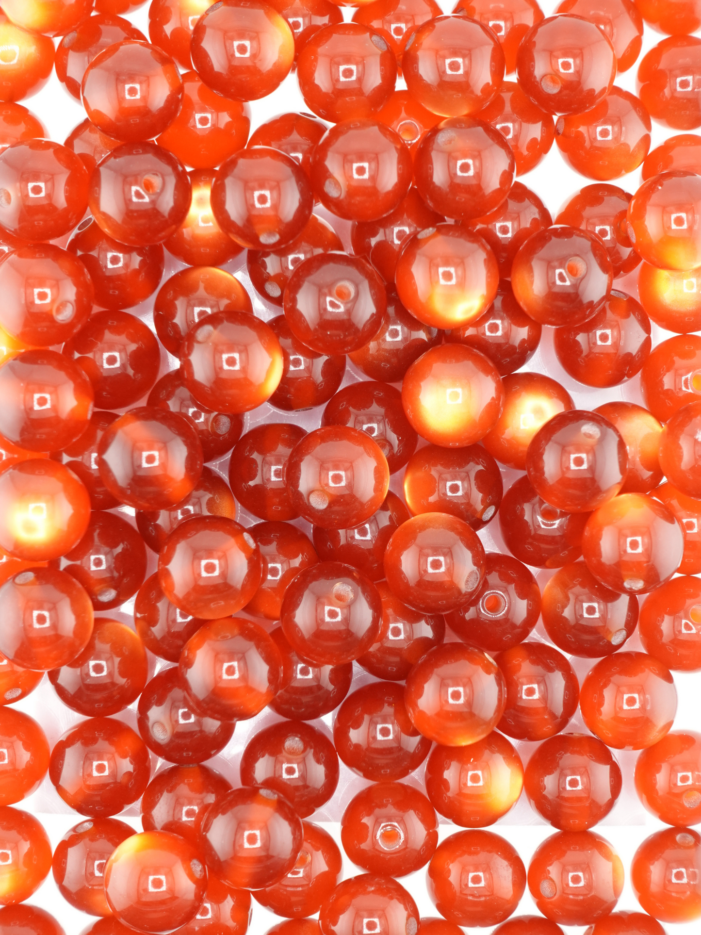 Collection of amber colored beads with a cat eye shimmer