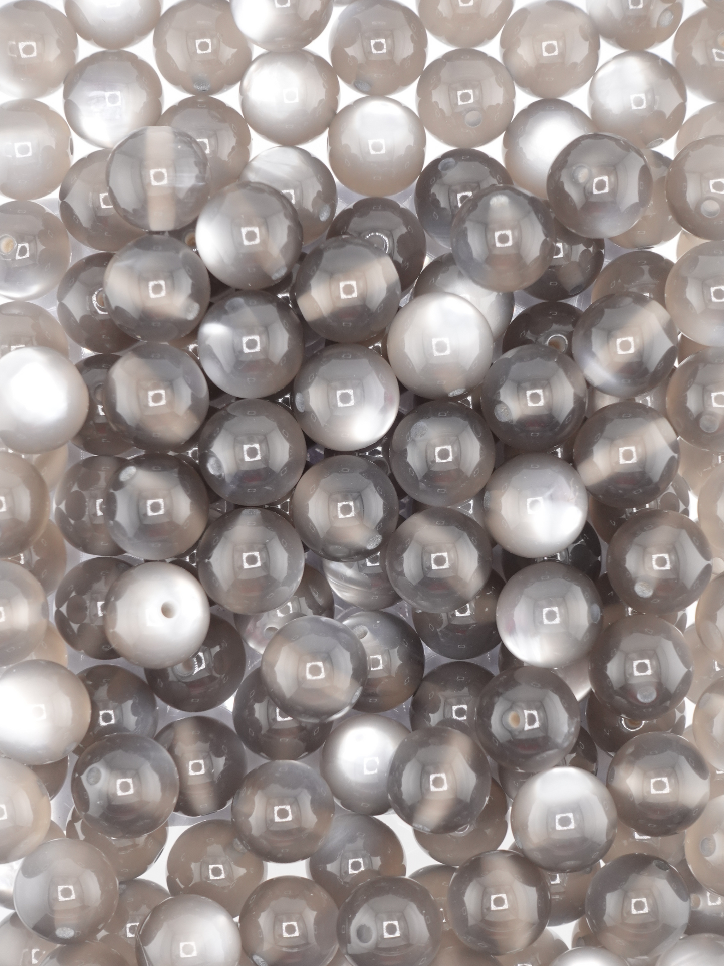 Collection of grey colored beads with a cat eye shimmer