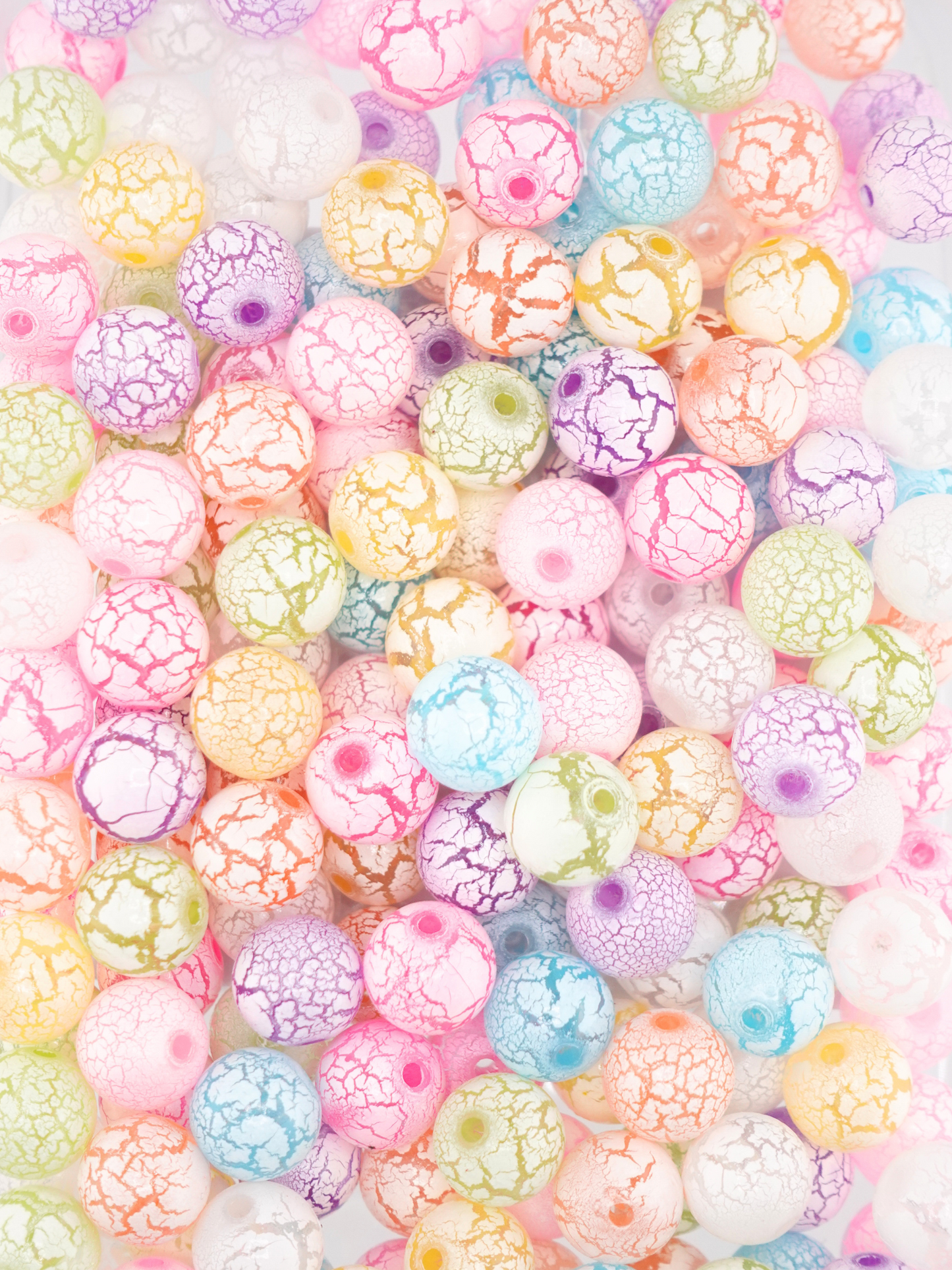 Collection of crackle beads in a variety of colors in yellow, pink, blue, green, orange