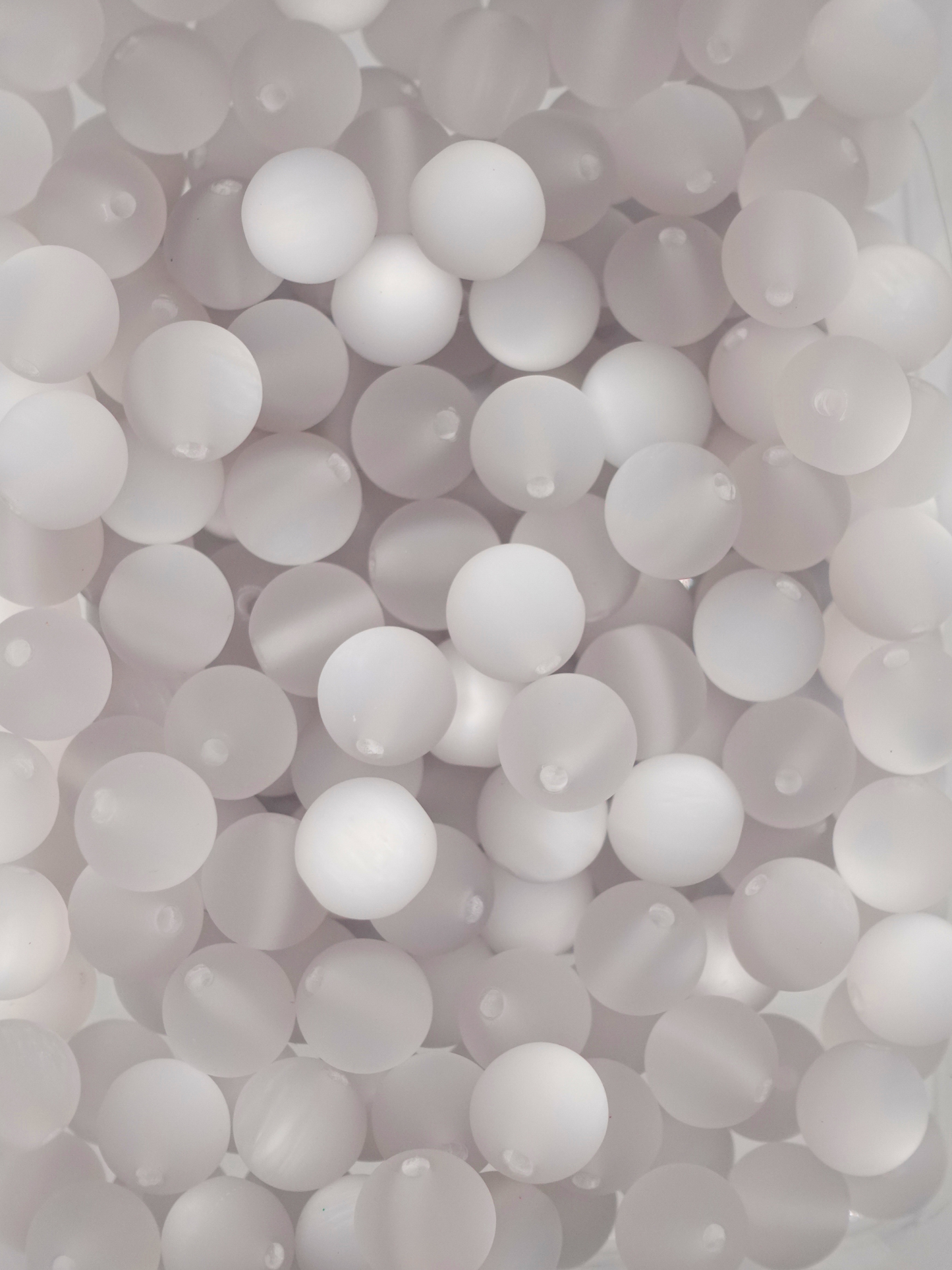 Collection of frosted cat eye beads with a light grey color