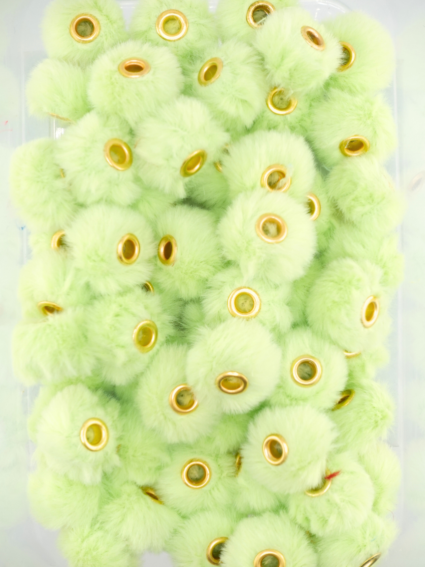 Collection of lime green fuzzy pom pom spacers