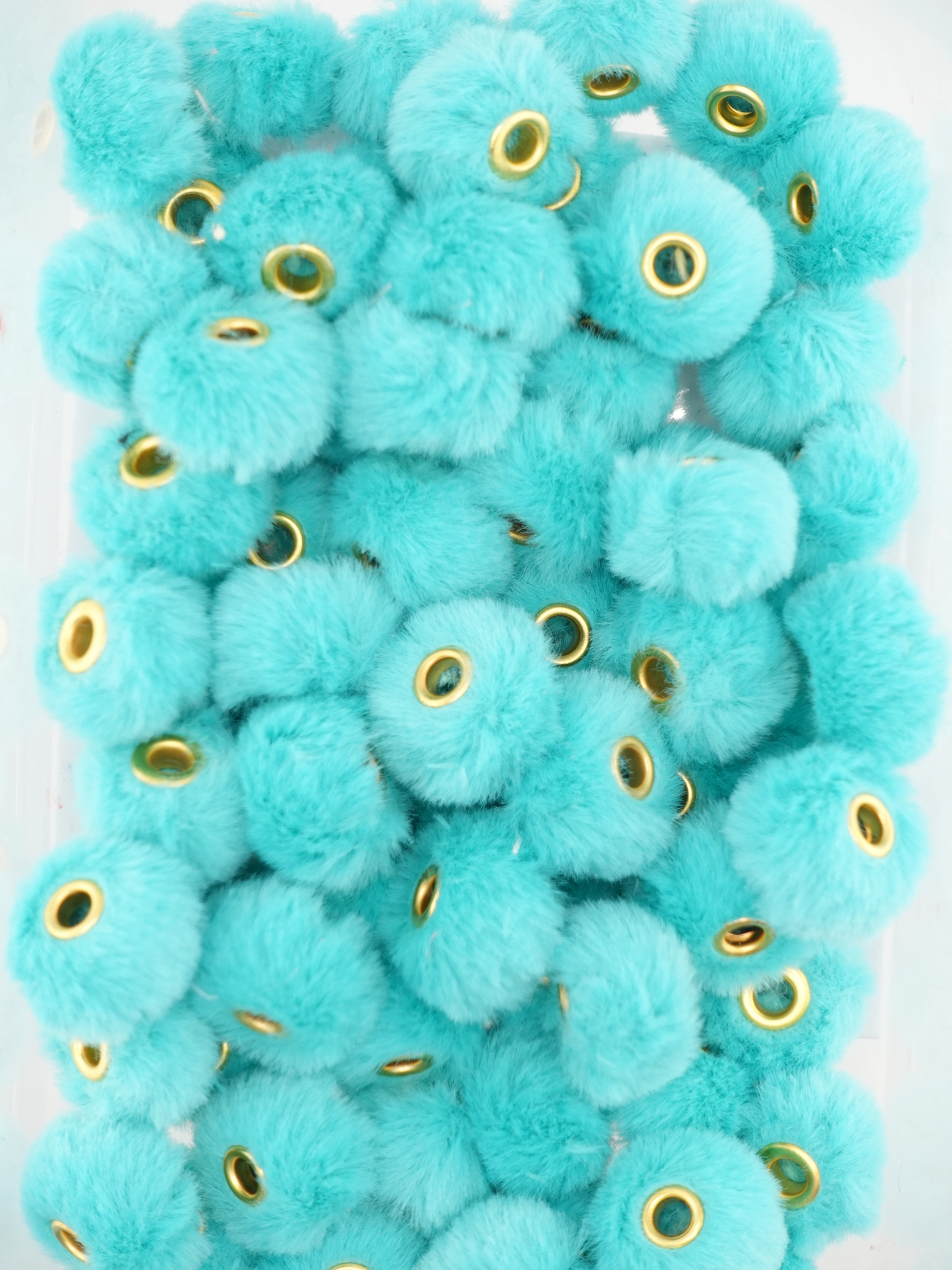 Collection of teal fuzzy pom pom spacers