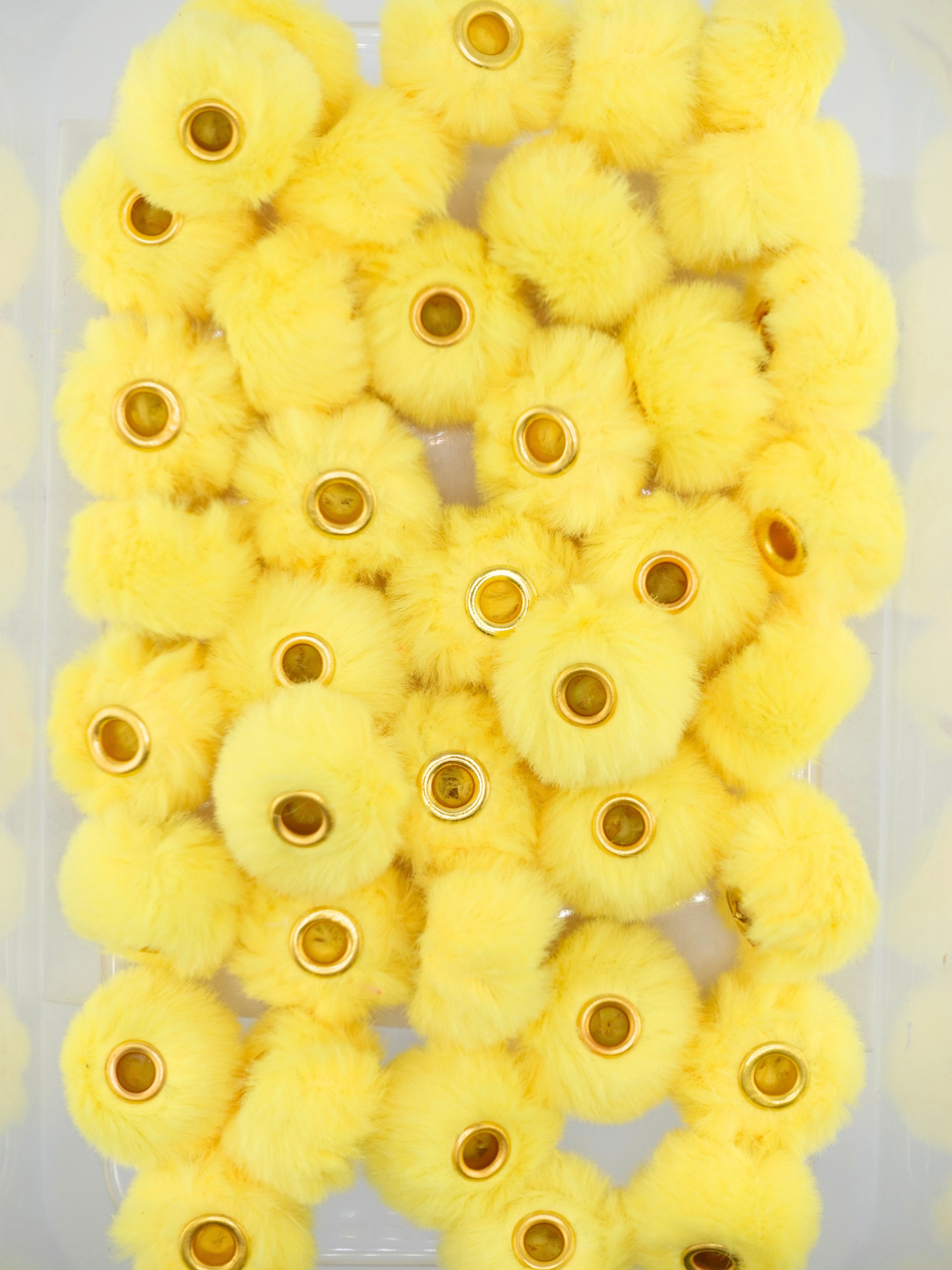 Collection of yellow fuzzy pom pom spacers