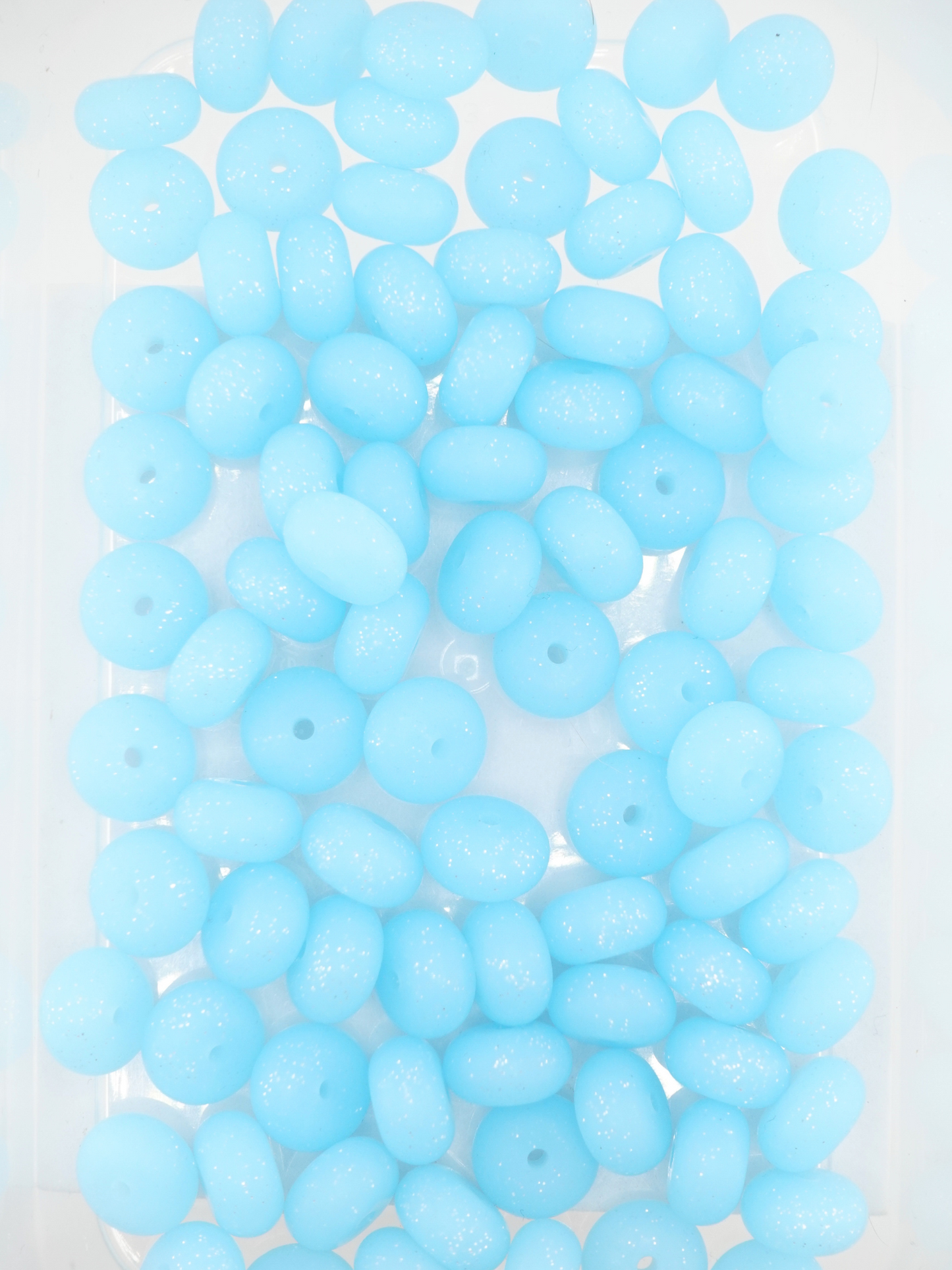 Collection of aqua blue colored silicone spacers with glitter