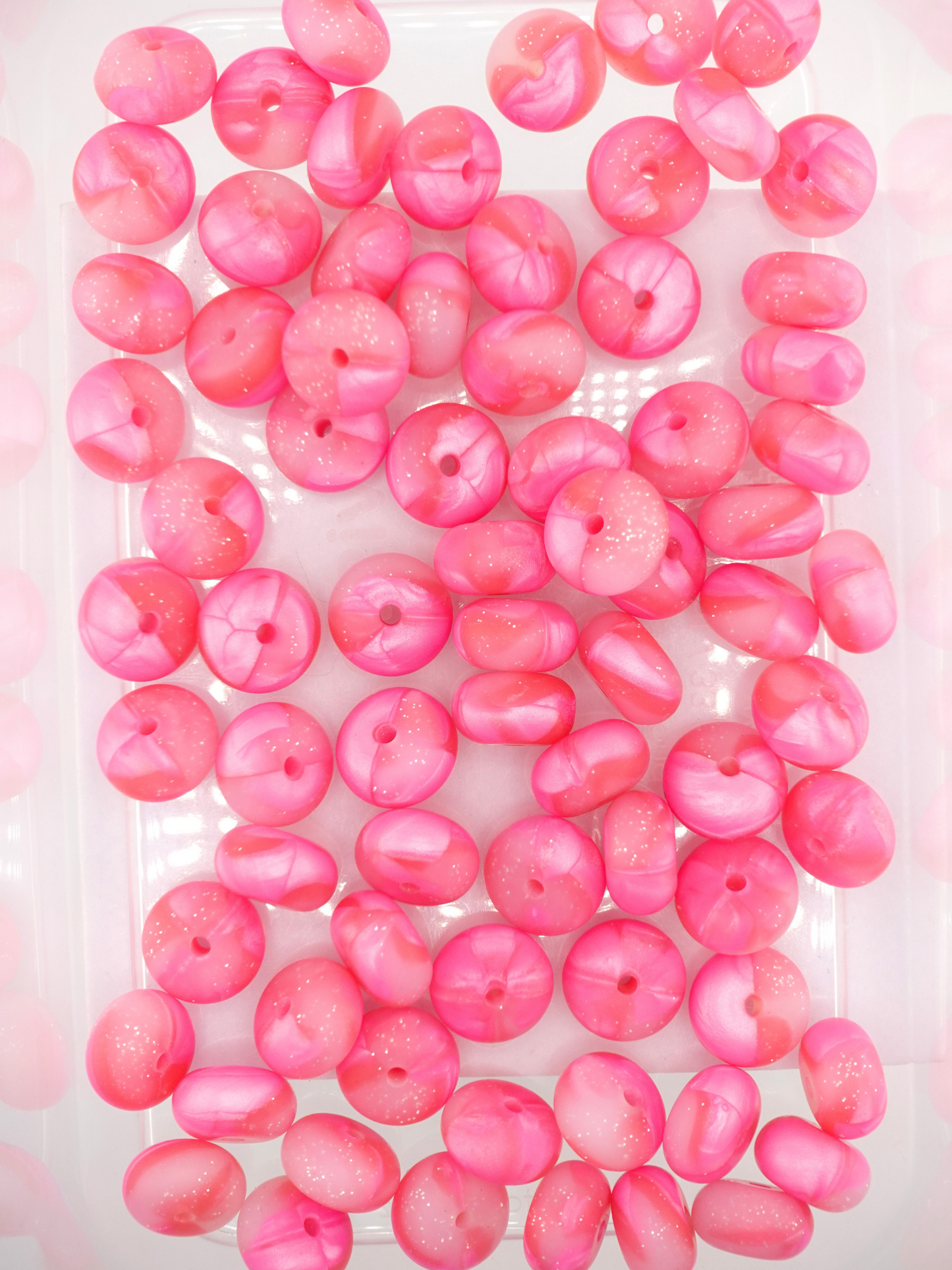 Collection of hot pink silicone spacers with swirl design