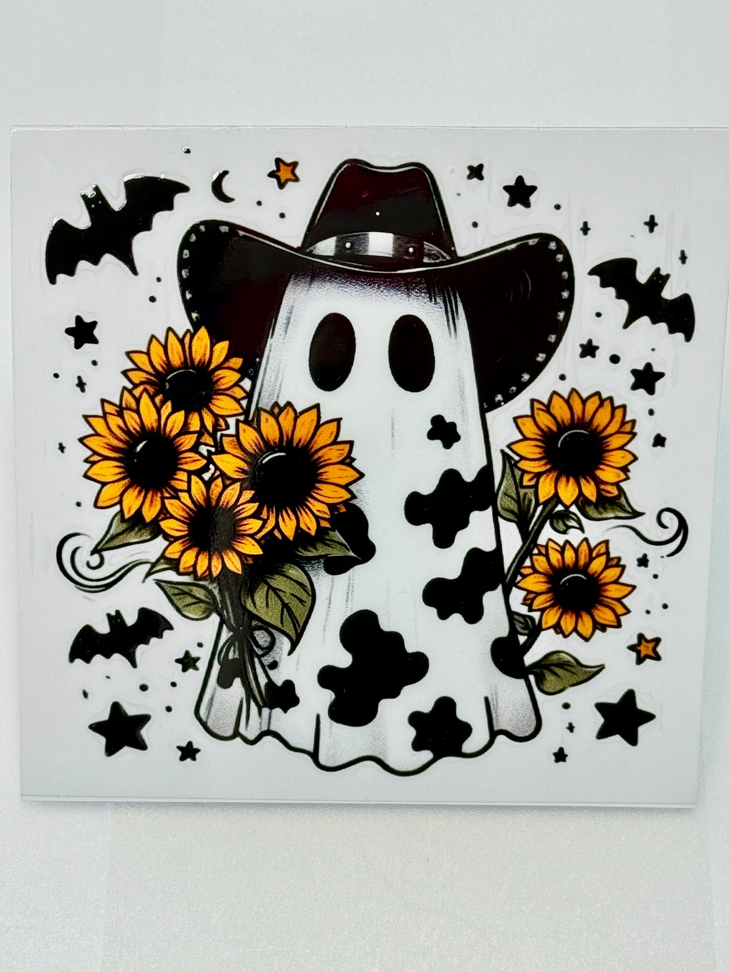 Ghost in a cowboy hat with sunflowers and bats on a white background