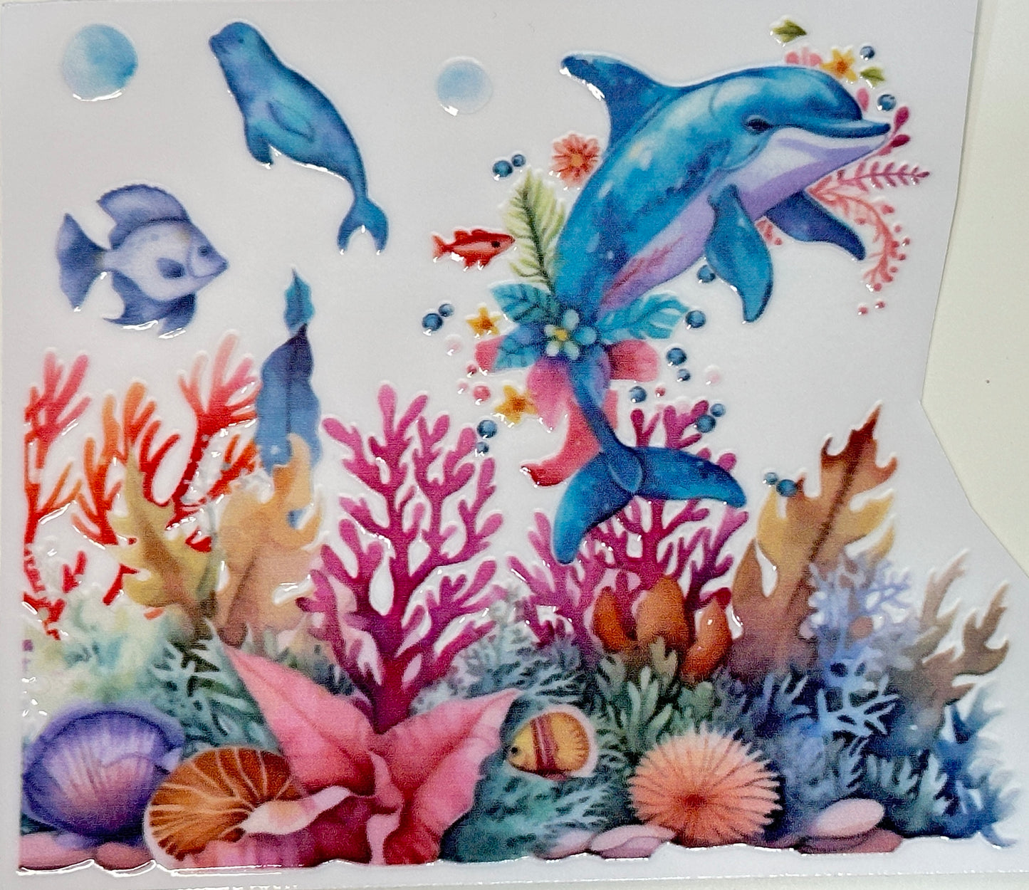 Colorful underwater scene with dolphins, fish, and coral