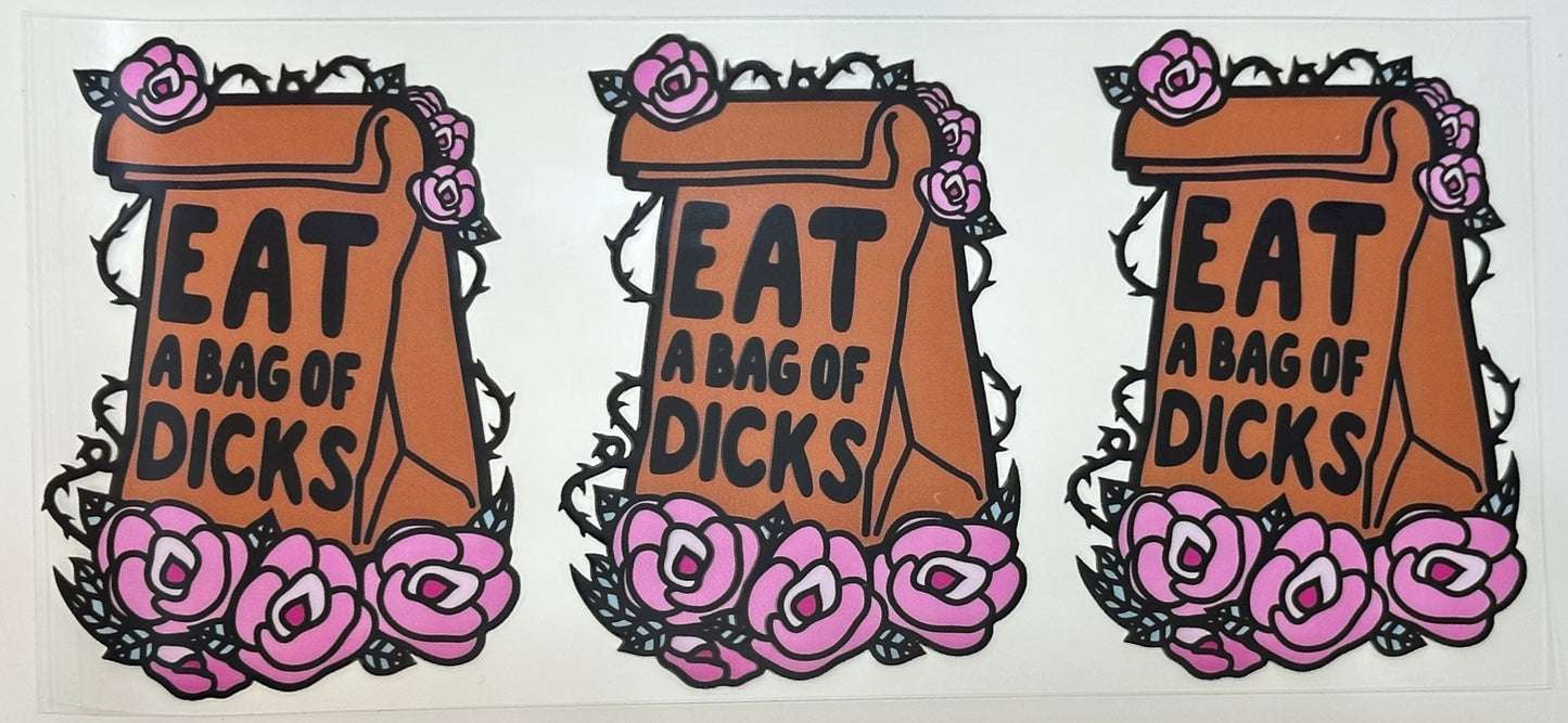 Three identical stickers with text 'EAT A BAG OF D!CKS' surrounded by floral designs