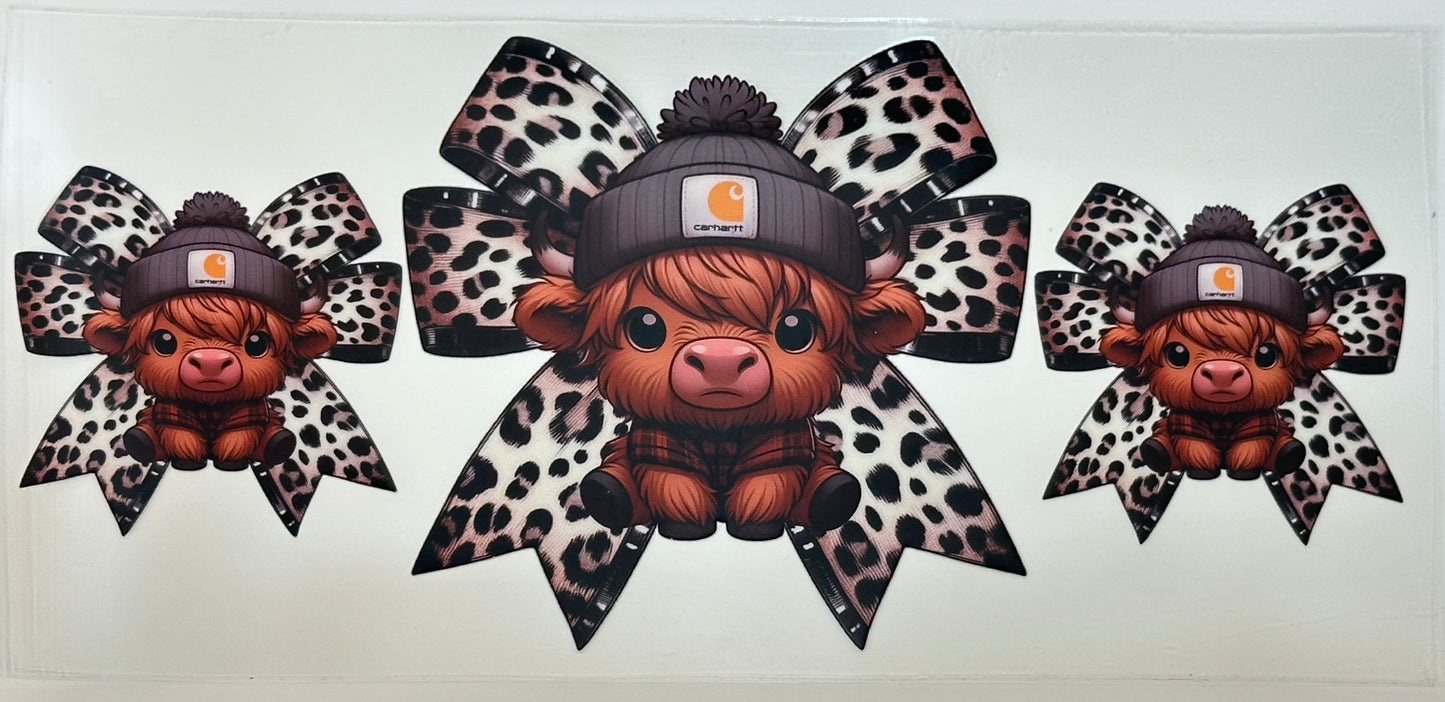Three cartoon cows wearing hats with leopard print bows