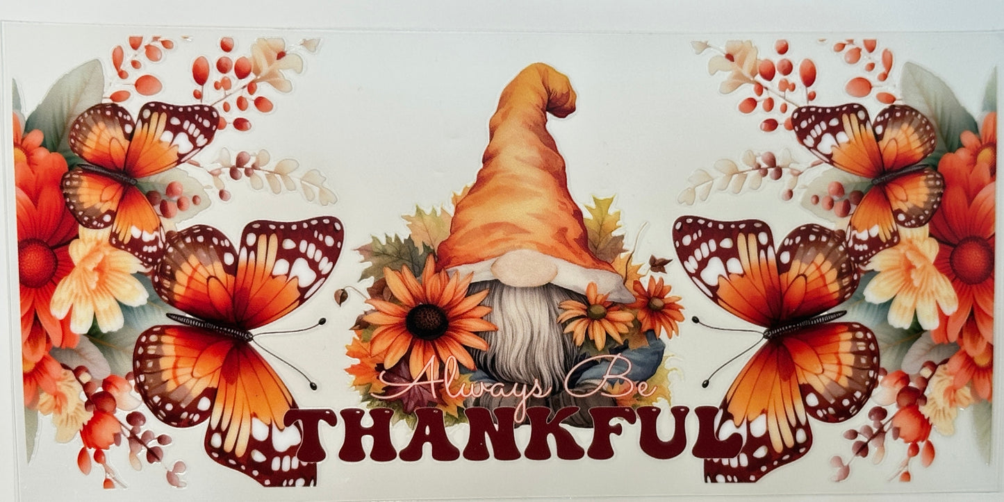 Decorative banner with butterflies, flowers, and a gnome with 'Always Be Thankful' text.