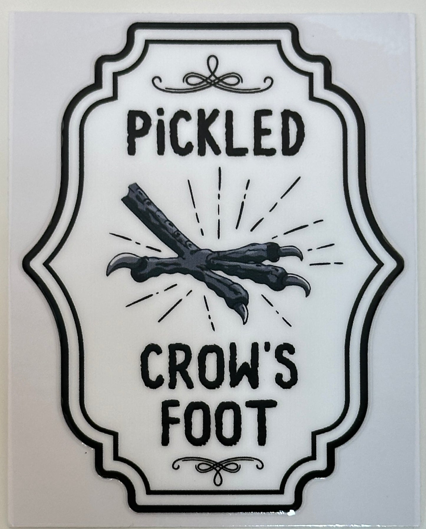 Decorative label with 'Pickled Crow's Foot' text and crossed bones design