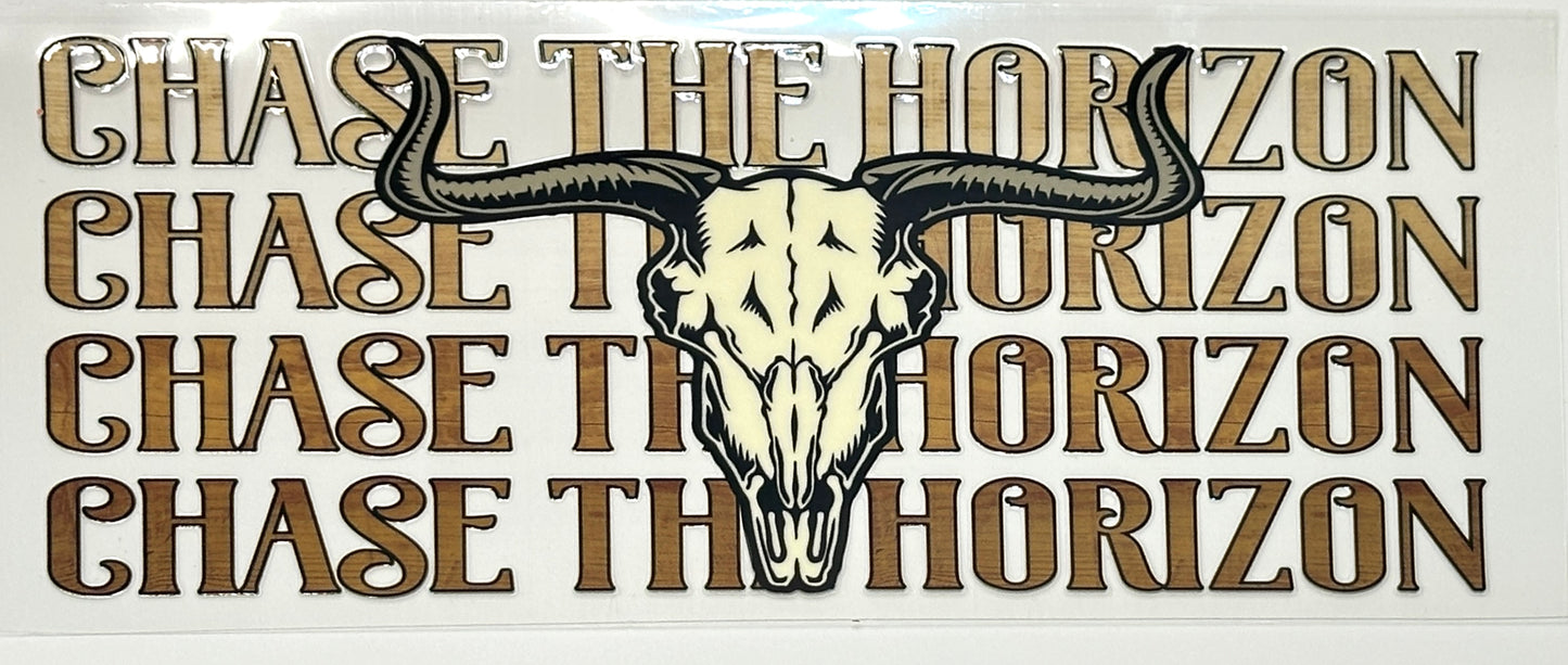 Decorative sign with bull skull and 'Chase the Horizon' text.