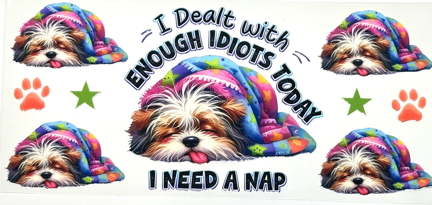 Dog wearing a colorful hoodie with text 'I Dealt with Enough Idiots Today, I Need a Nap' surrounded by paw prints and stars.