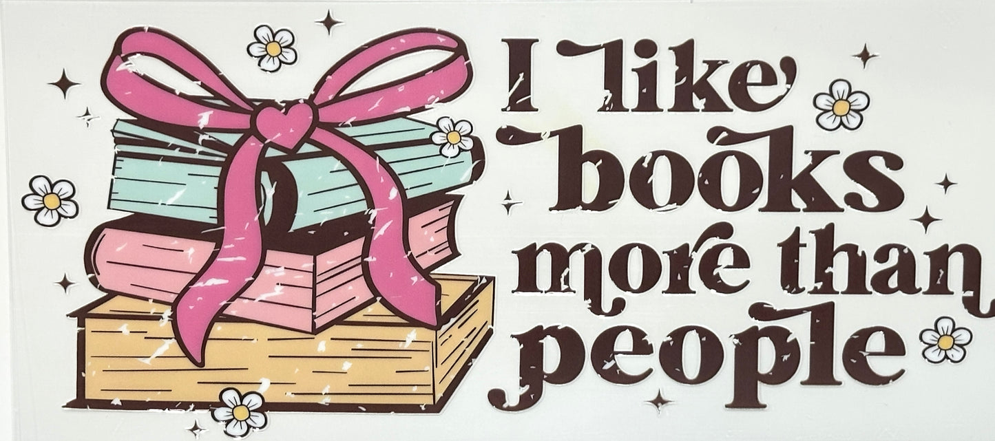 Illustration of books with a pink bow and text 'I like books more than people' on a light background.