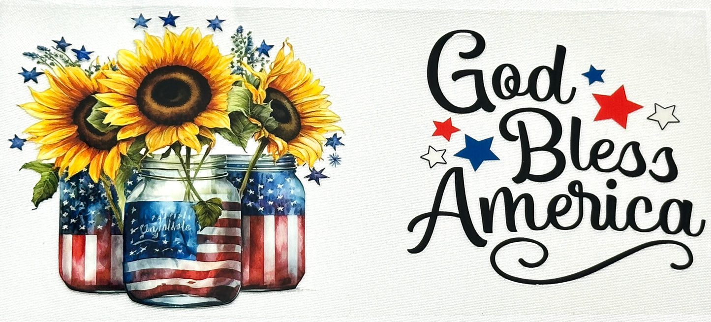 Decorative sign with sunflowers in American flag jars and 'God Bless America' text.
