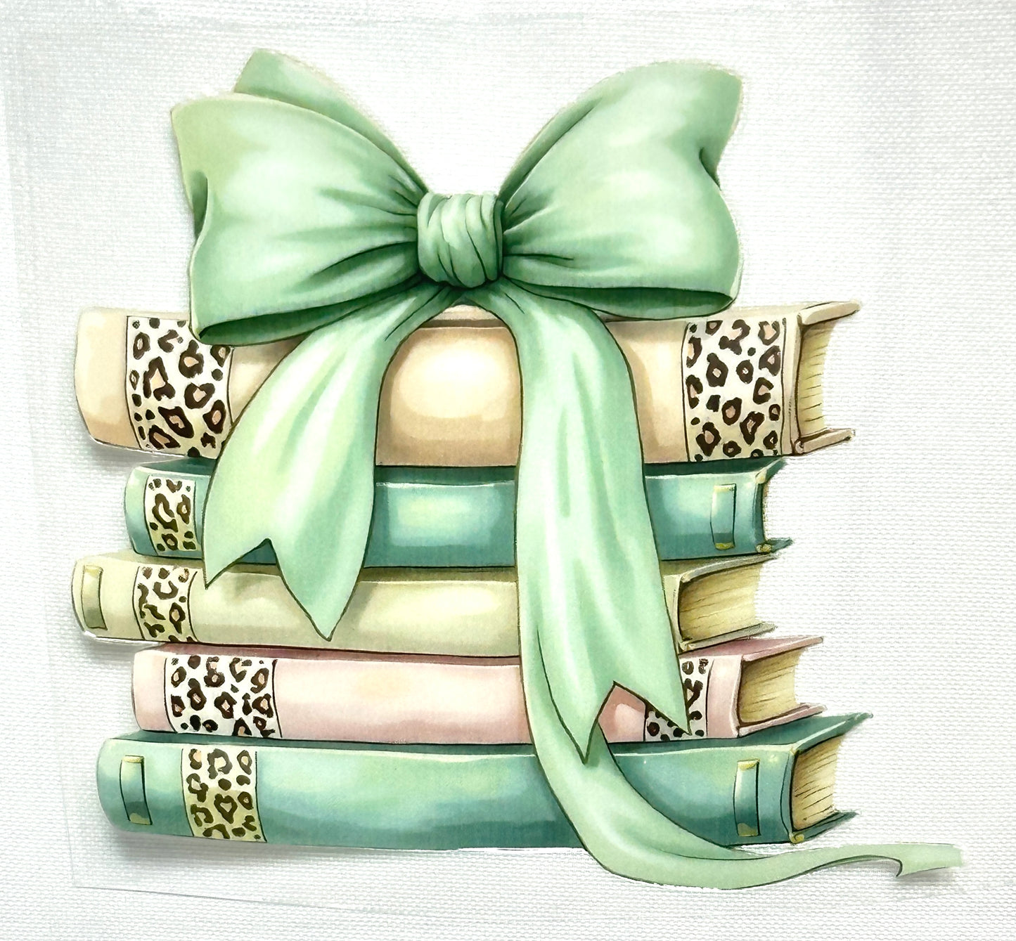 Stack of books with a green bow on a light background