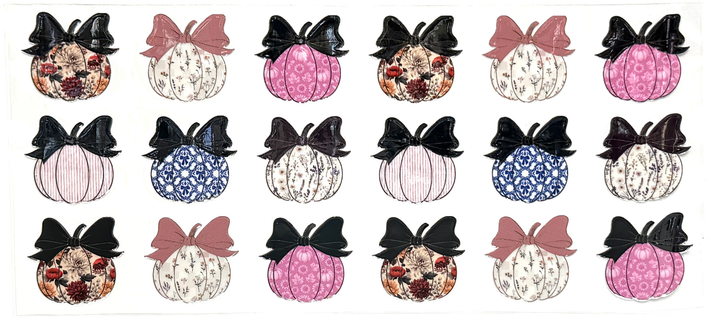Set of decorative pumpkins with bows on a white background