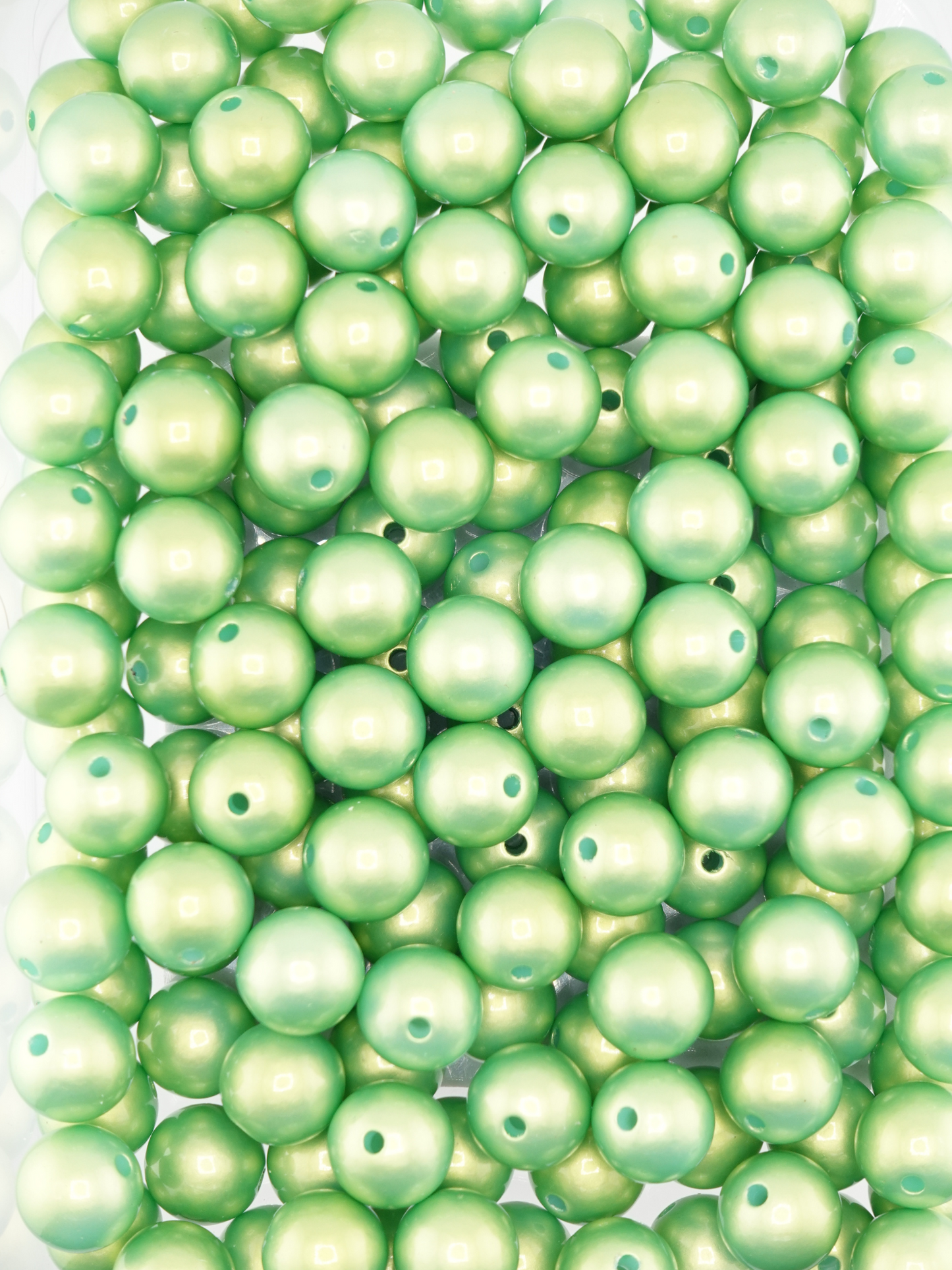 Collection of green colored beads with a pearl shimmer finish