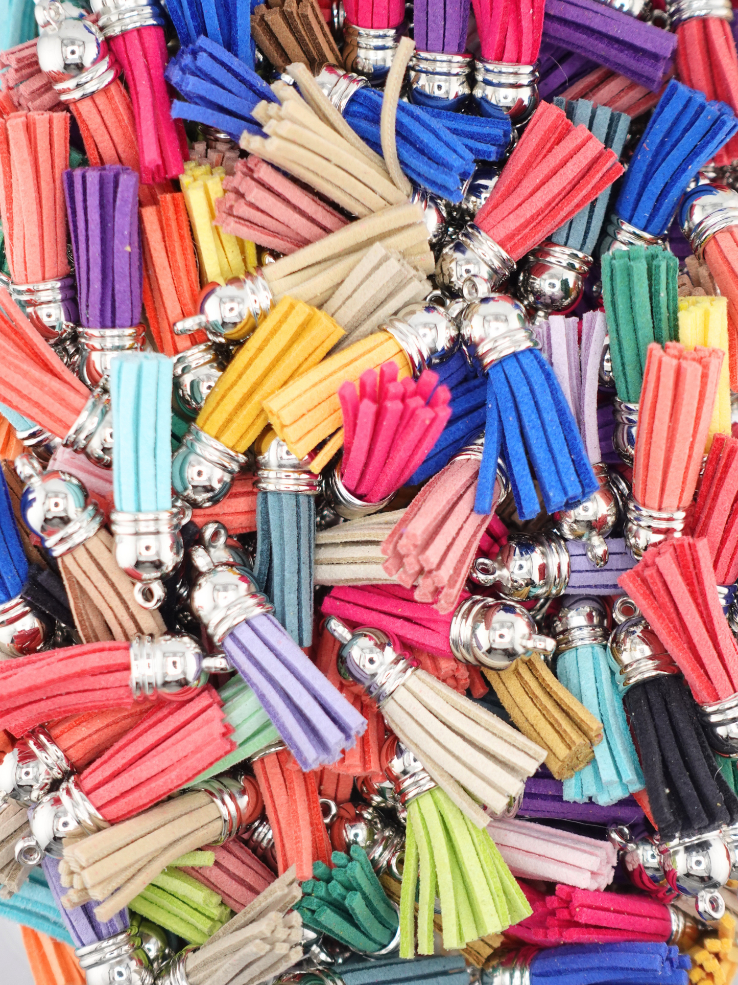 Collection of tassel beads with varying colors: blue, light blue, pink, orange, yellow, red black, lime green
