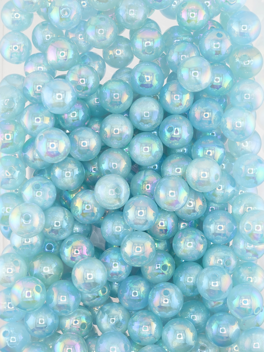 Collection of light blue colored beads with an aurora borealis and galaxy shimmer