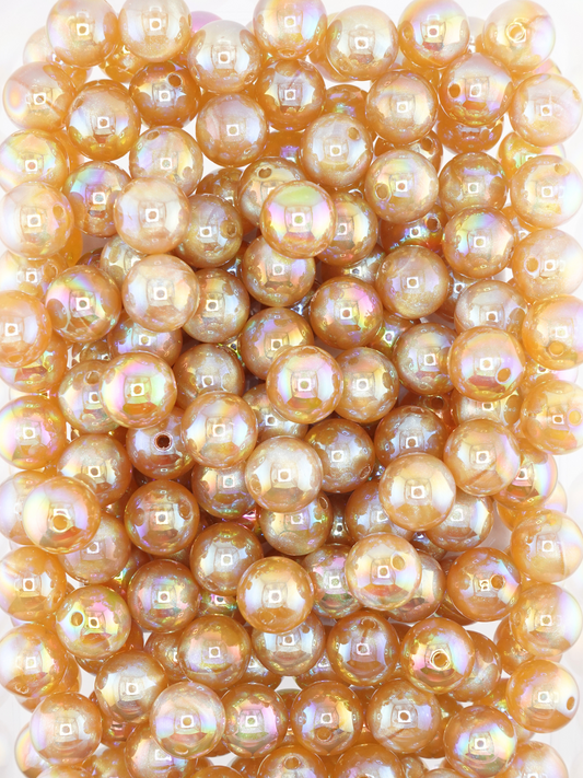 Collection of champagne colored beads with an aurora borealis and galaxy shimmer