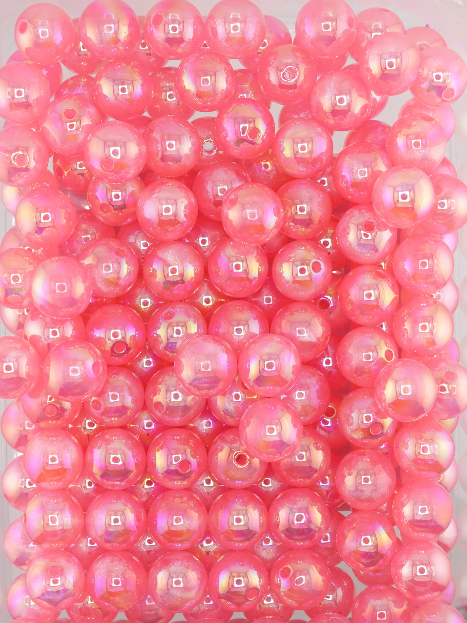 Collection of dark pink colored beads with an aurora borealis and galaxy shimmer