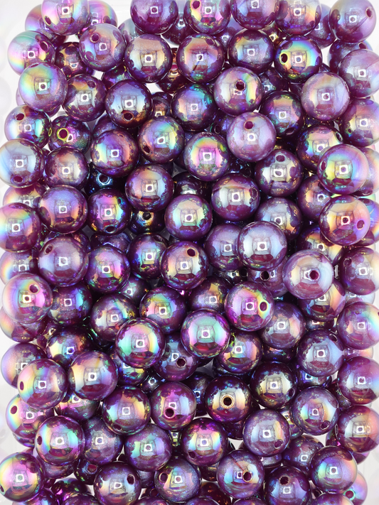 Collection of dark purple colored beads with an aurora borealis and galaxy shimmer