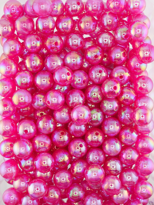 Collection of fuchsia colored beads with an aurora borealis and galaxy shimmer