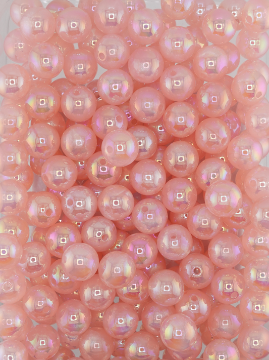 Collection of light pink colored beads with an aurora borealis and galaxy shimmer