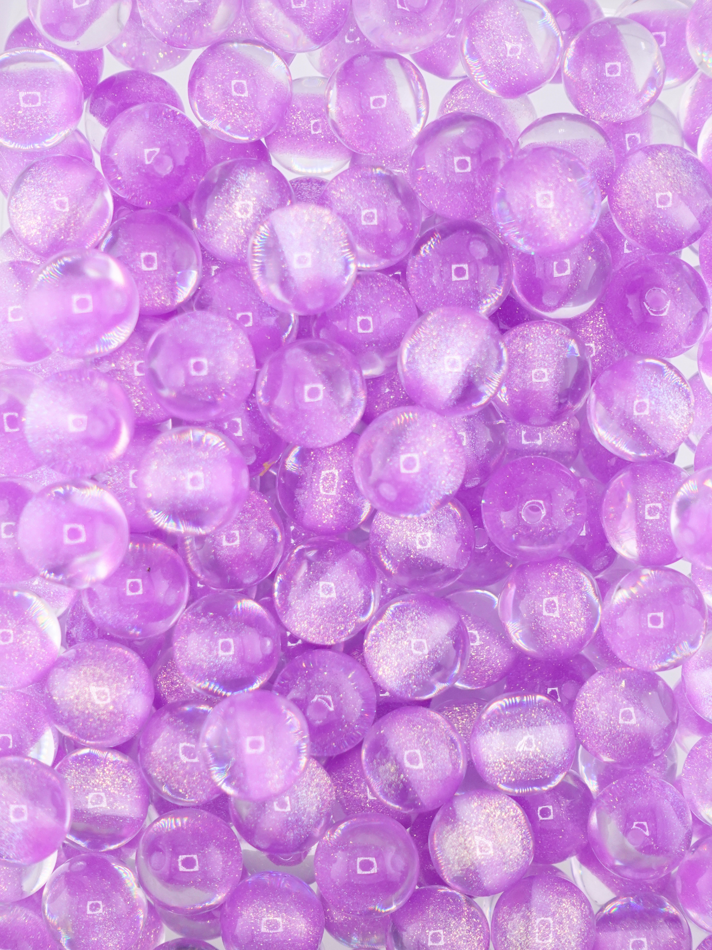 Collection of purple colored glitter beads with an aurora borealis finish
