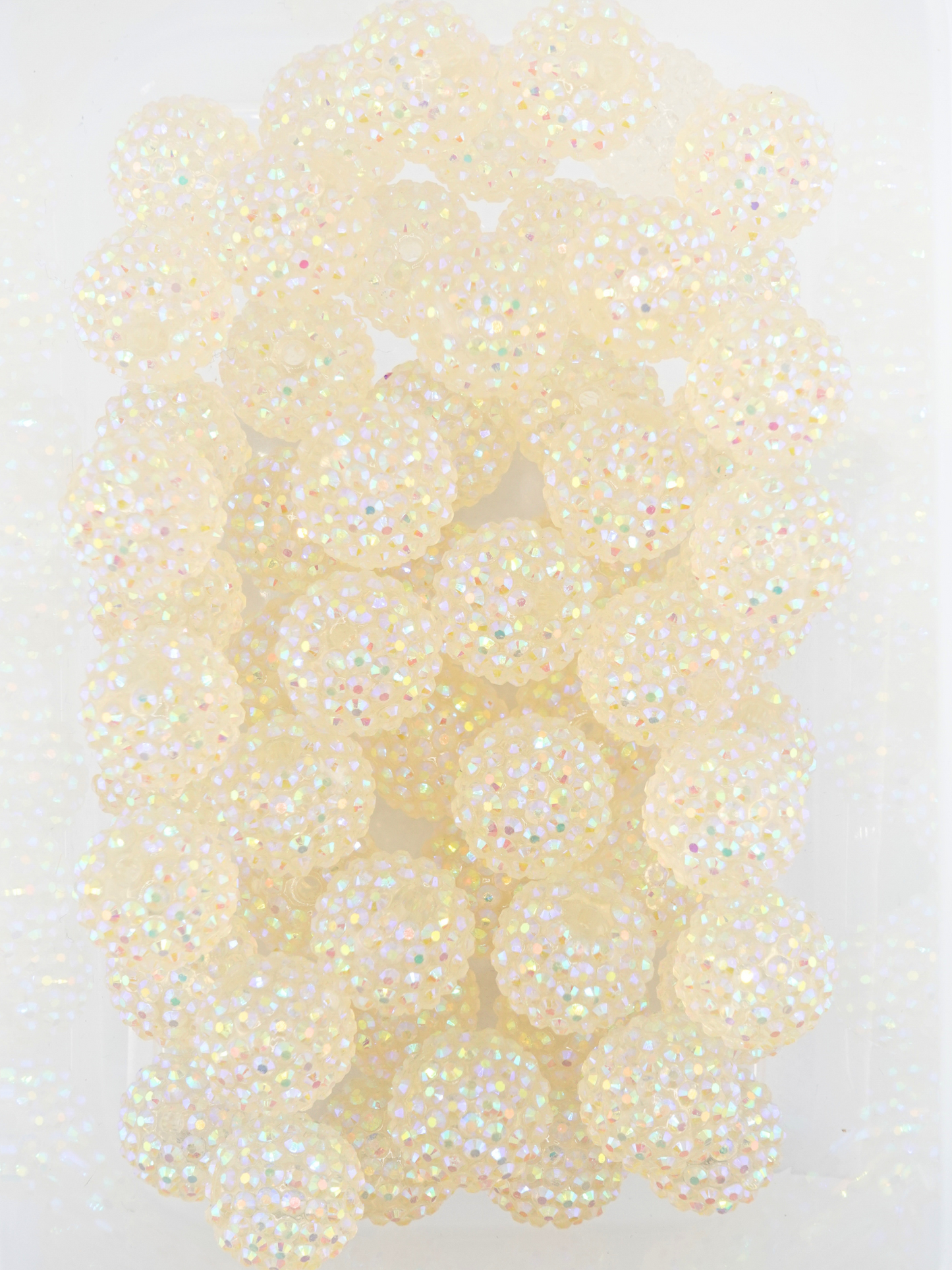 Collection of white beads with a rhinestone texture
