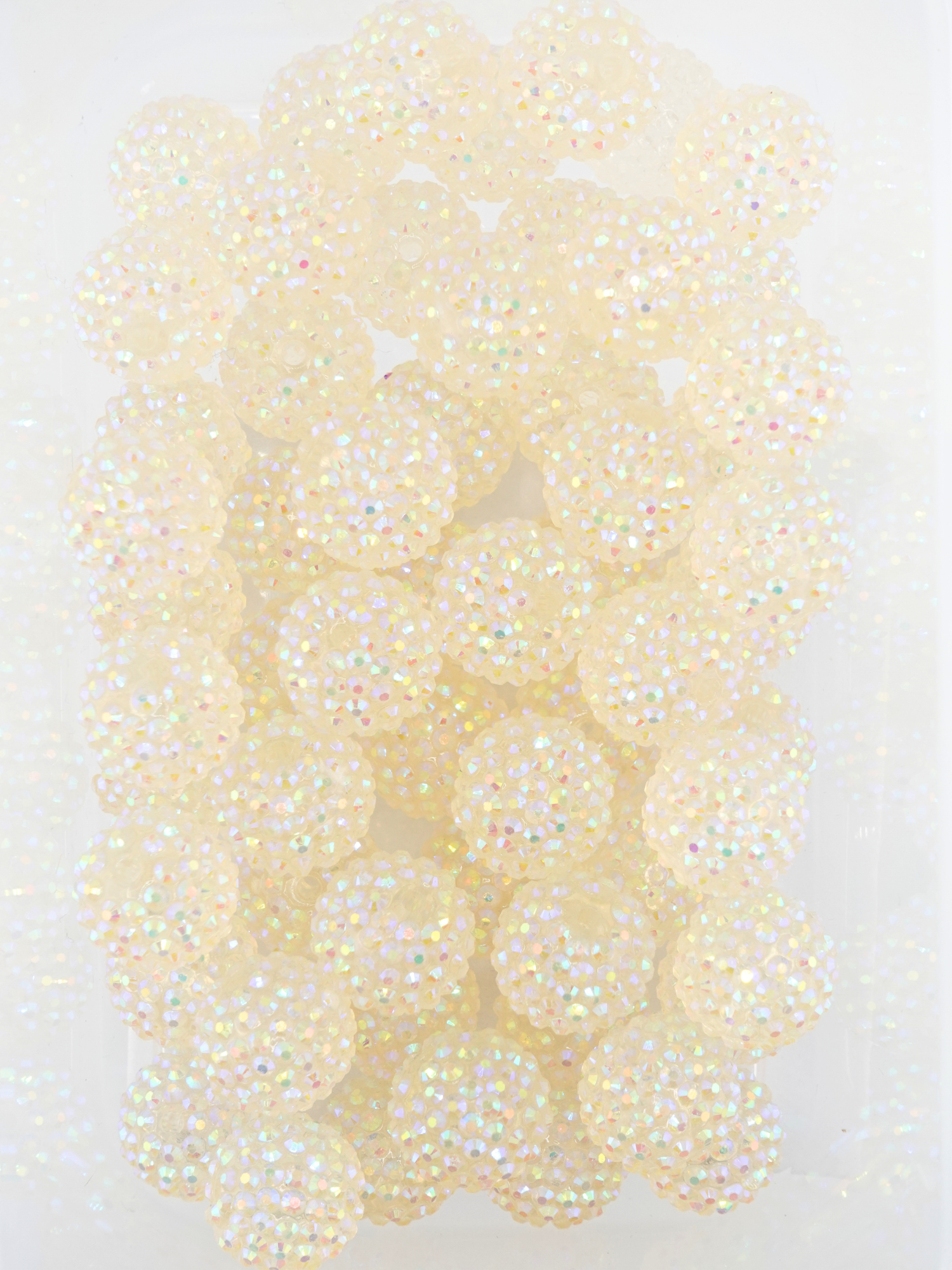 Collection of white beads with a rhinestone texture