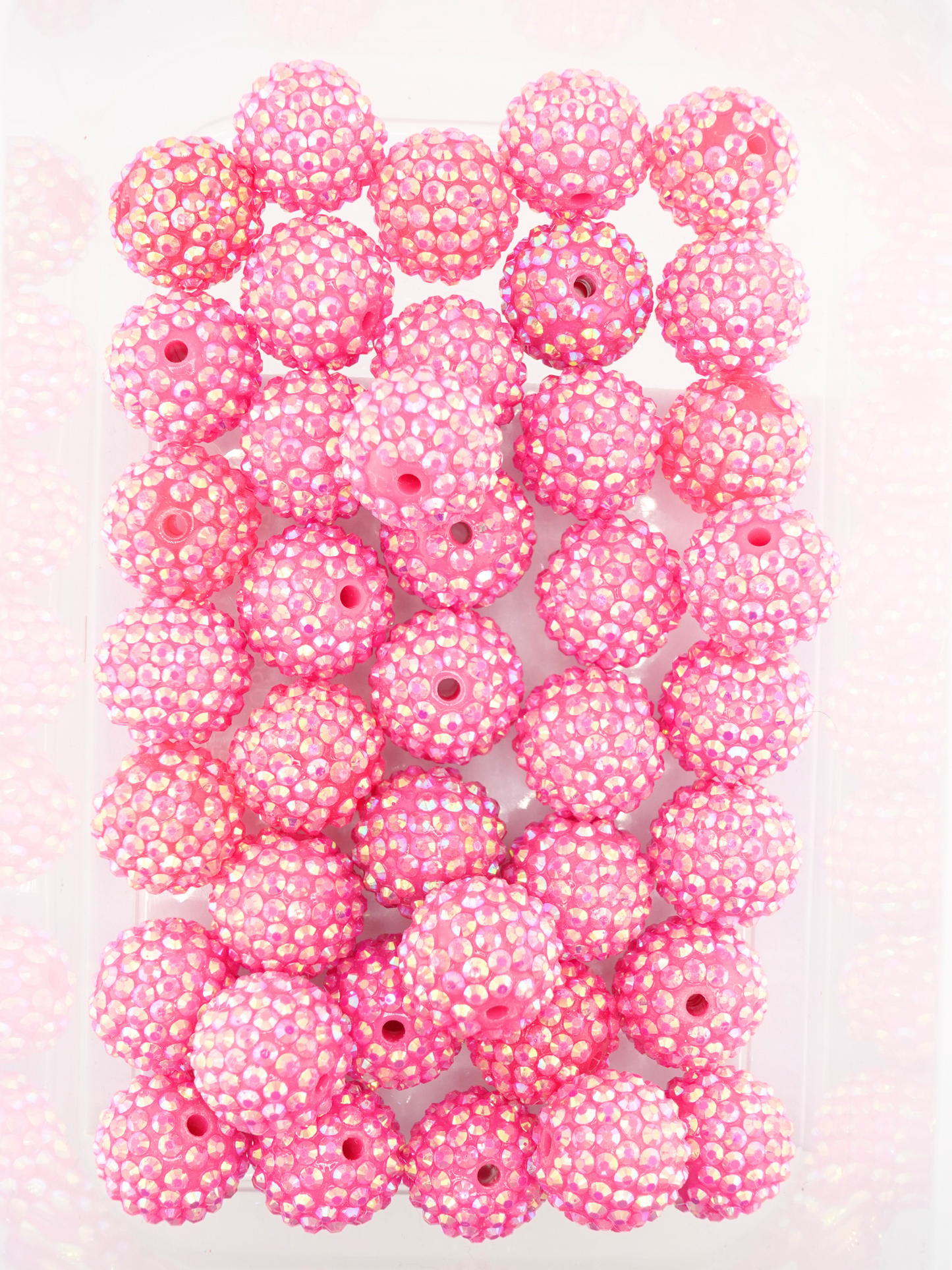 Collection of hot pink beads with a rhinestone texture