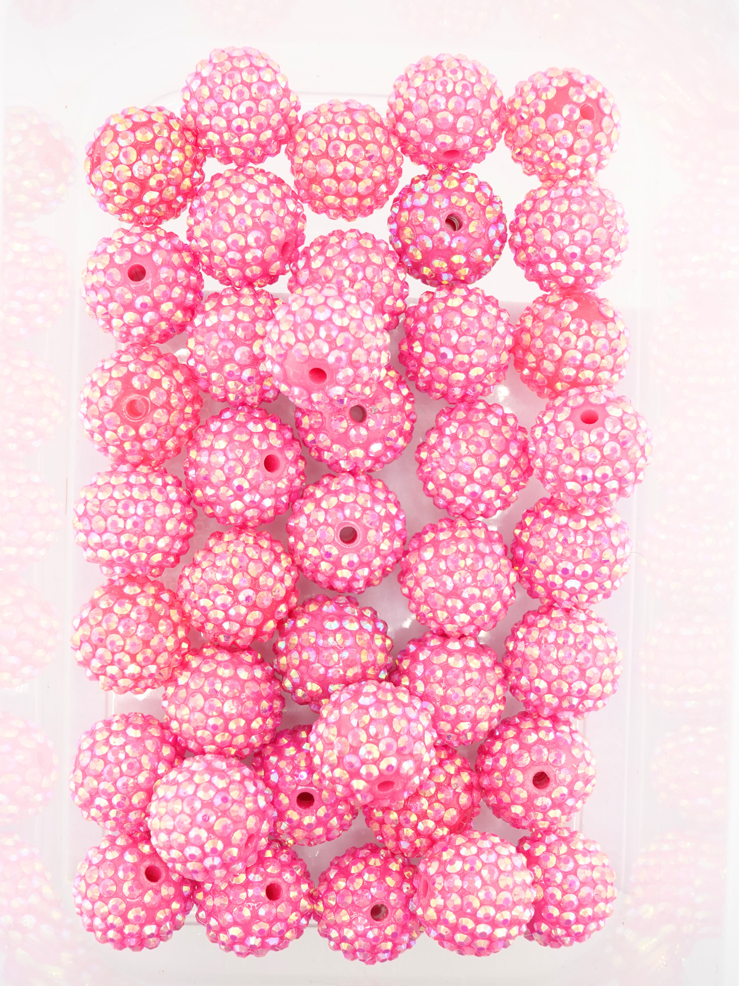 Collection of hot pink beads with a rhinestone texture