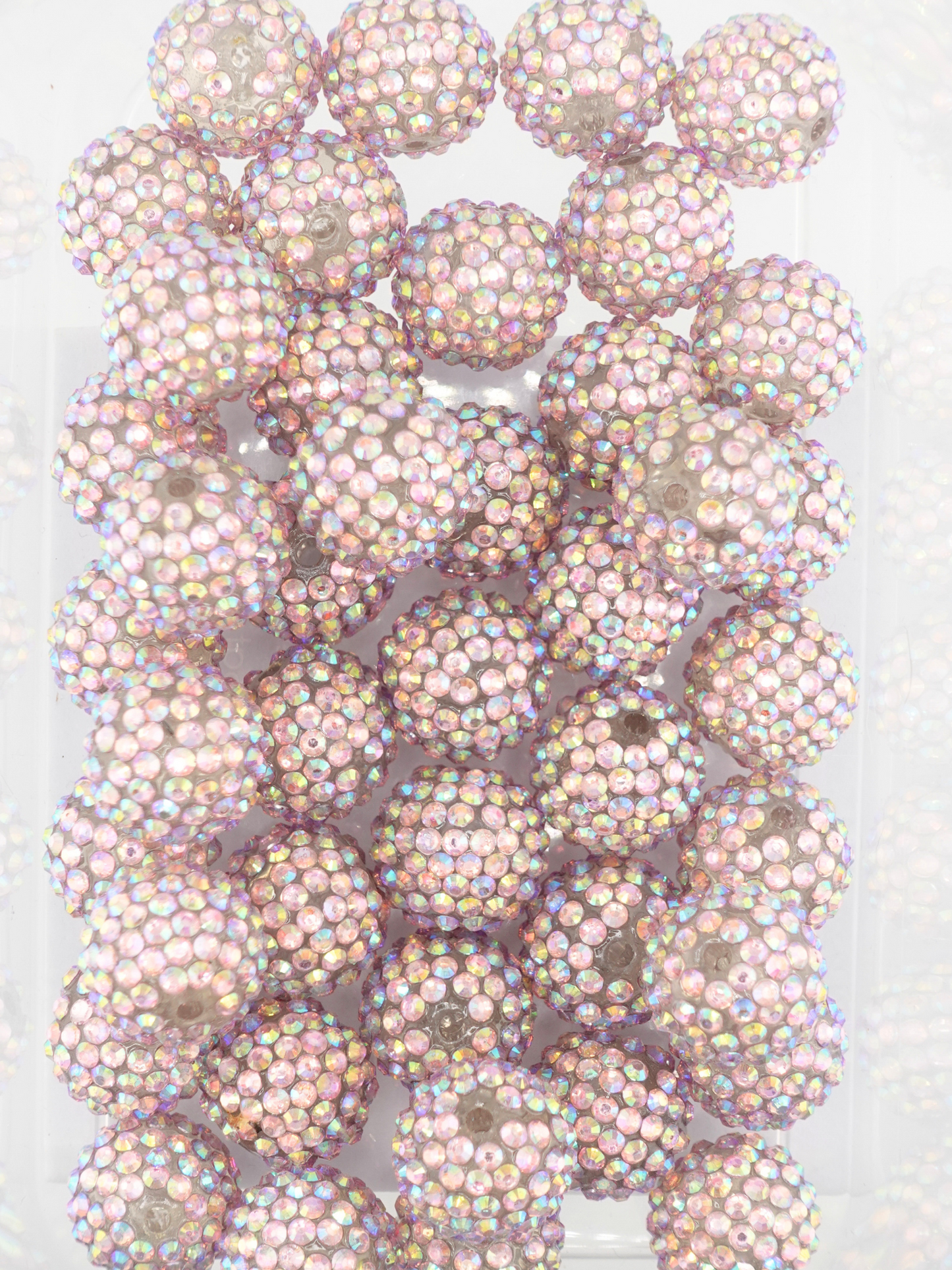 Collection of pastel multicolored beads with shiny aurora borealis finish and rhinestone texture