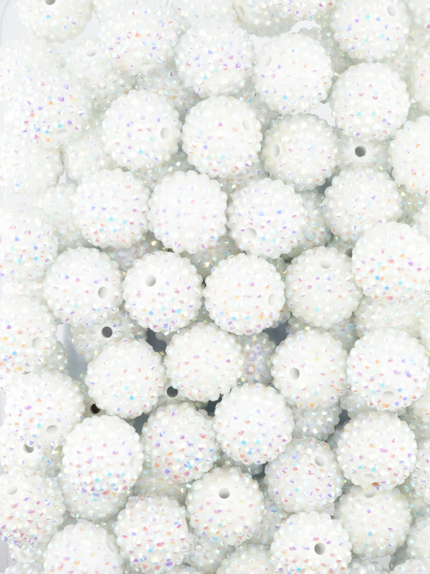 Collection of white beads with a rhinestone texture