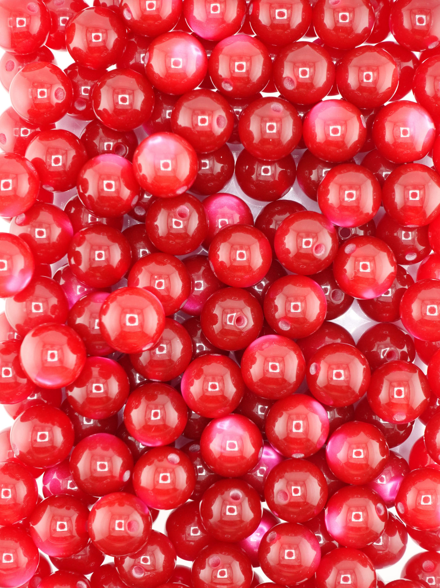 Collection of burgundy colored beads with a cat eye shimmer