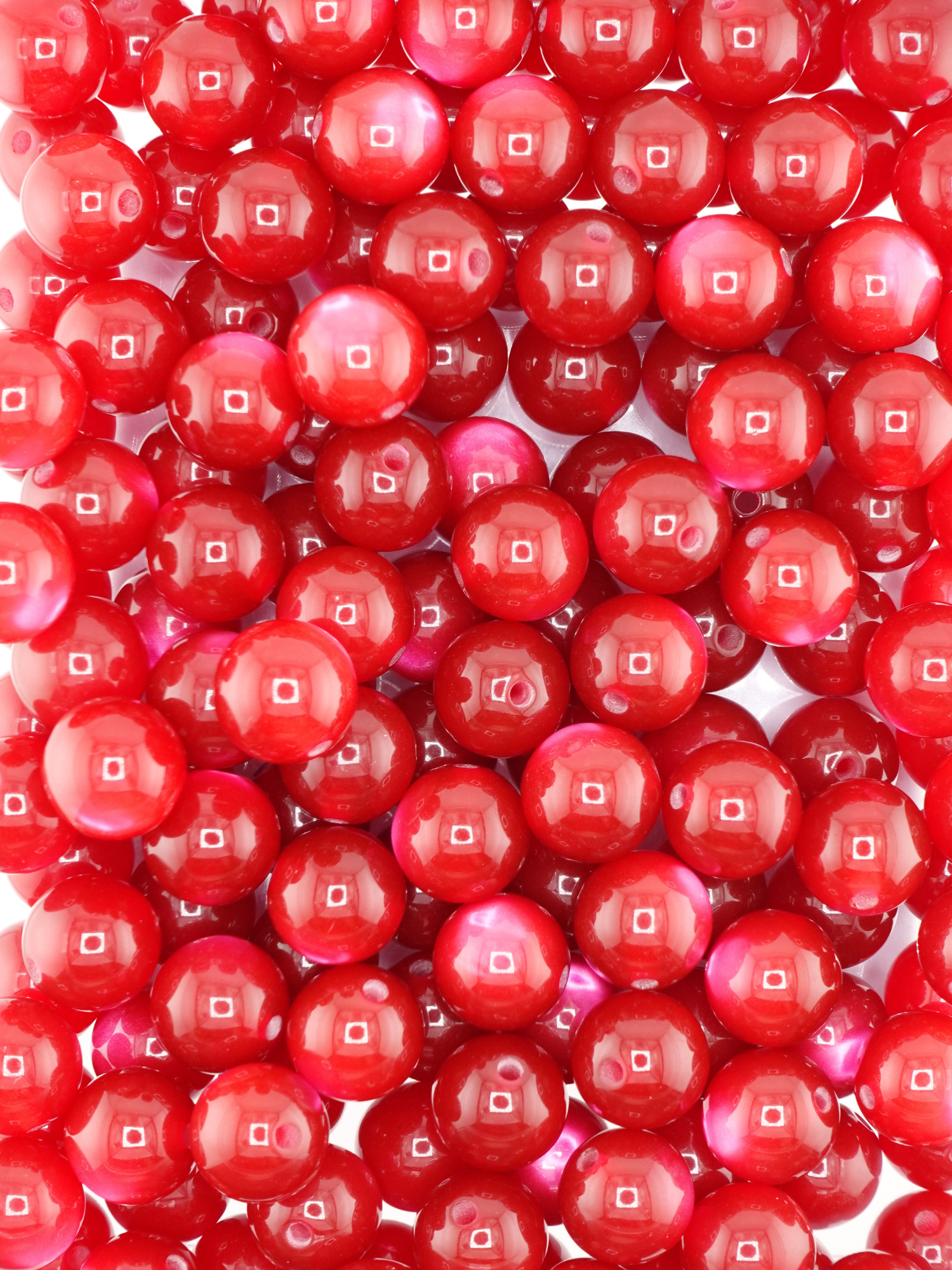 Collection of burgundy colored beads with a cat eye shimmer