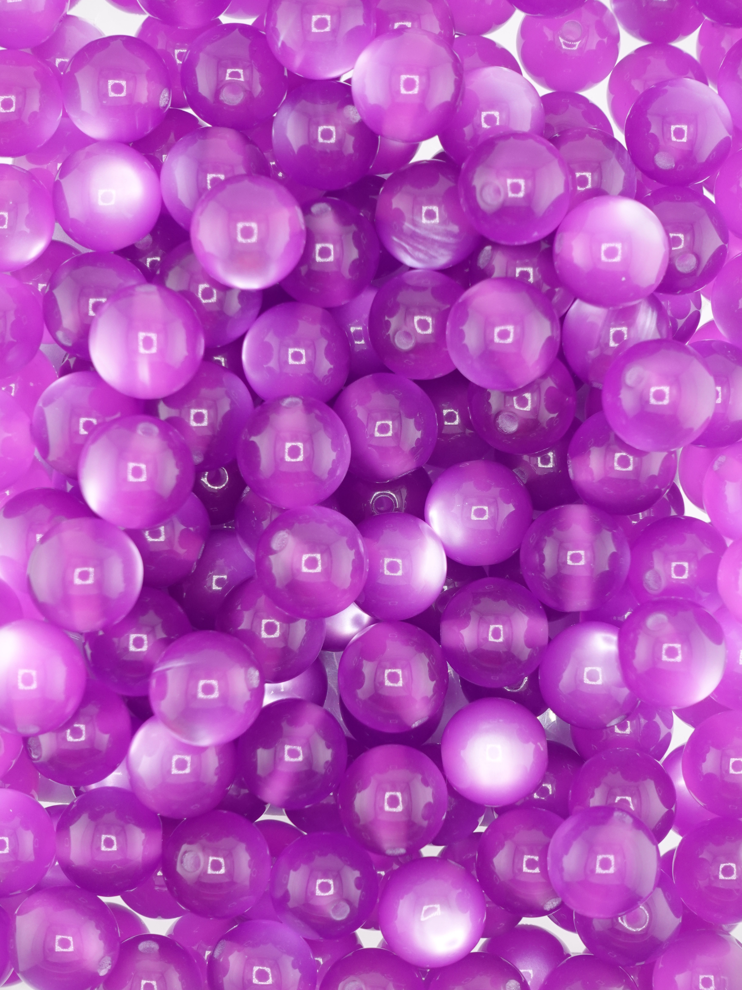 Collection of grape purple colored beads with a cat eye shimmer