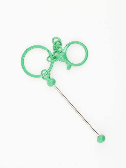 A single dark green colored beadable keychain