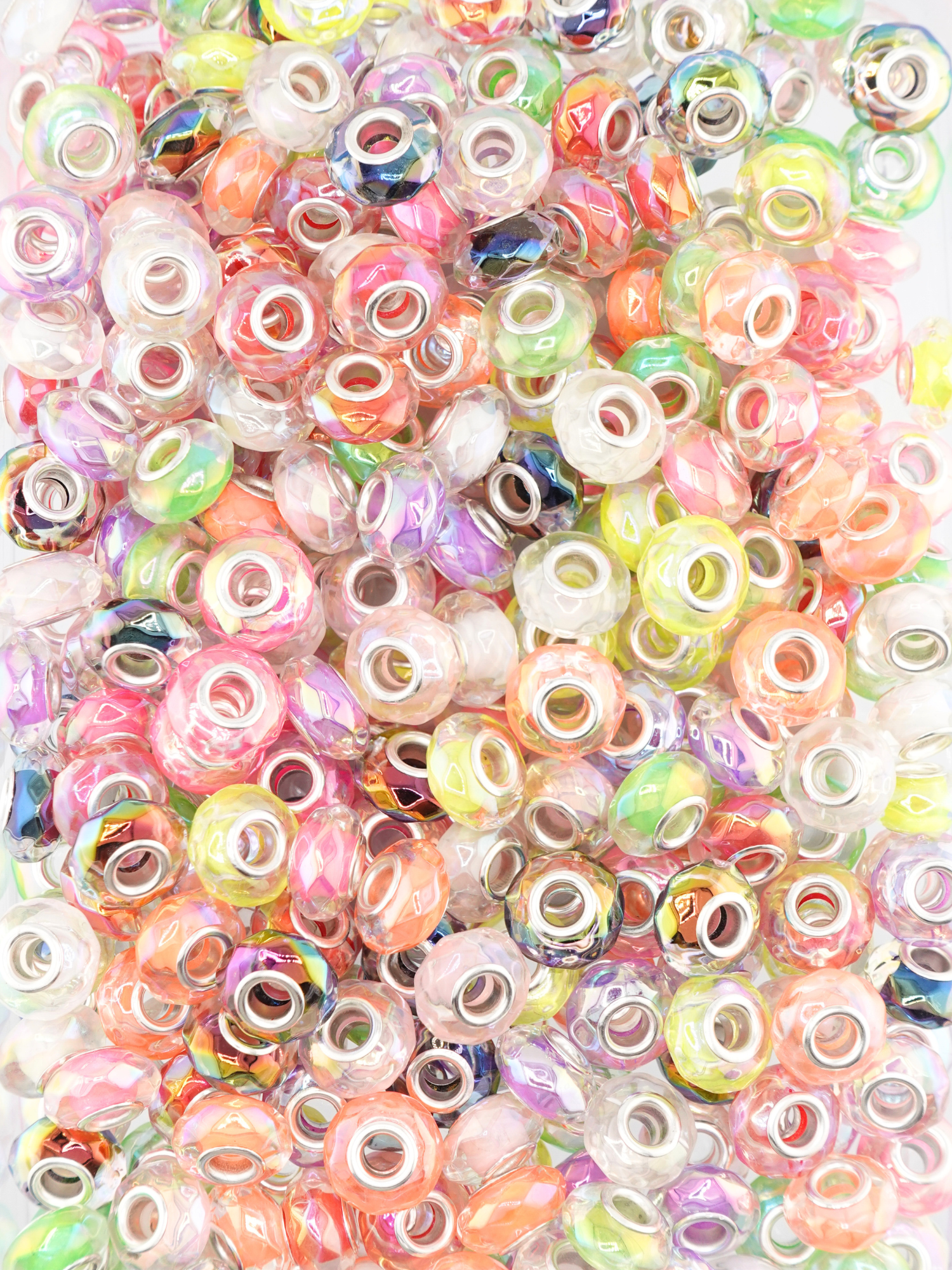Collection of different colored clear spacers with a faceted texture