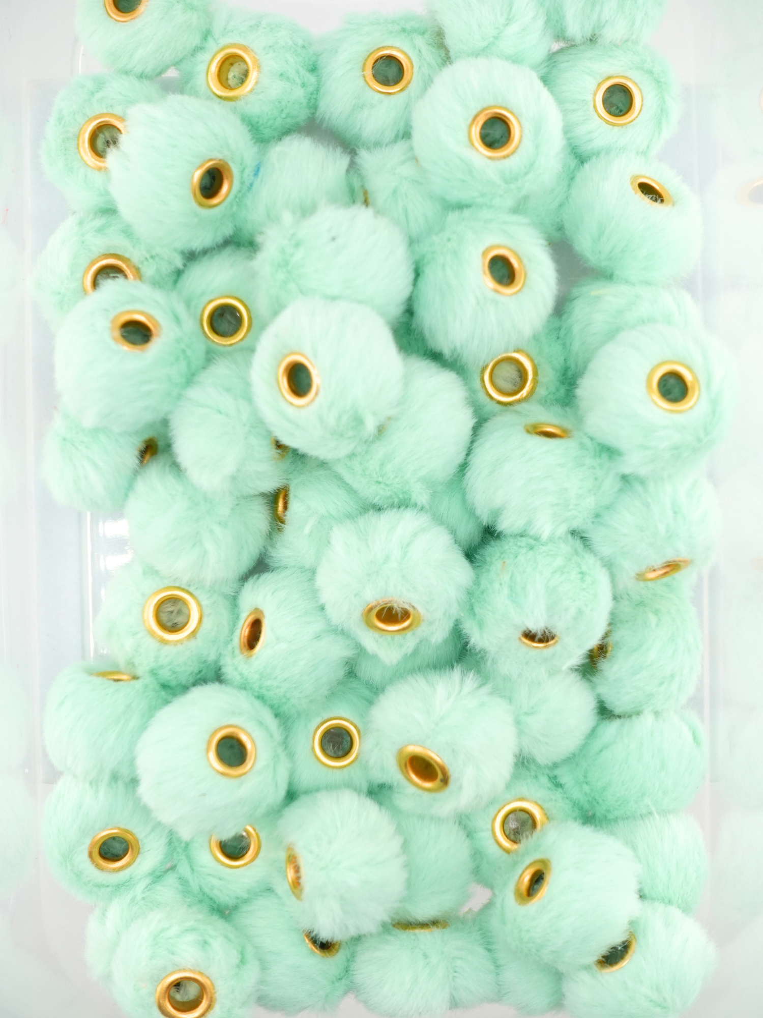 Collection of mint colored fuzzy pom pom spacers
