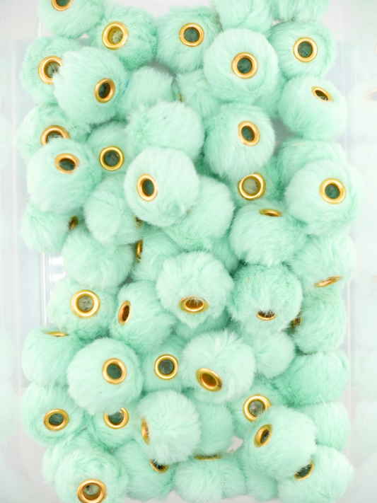 Collection of mint colored fuzzy pom pom spacers