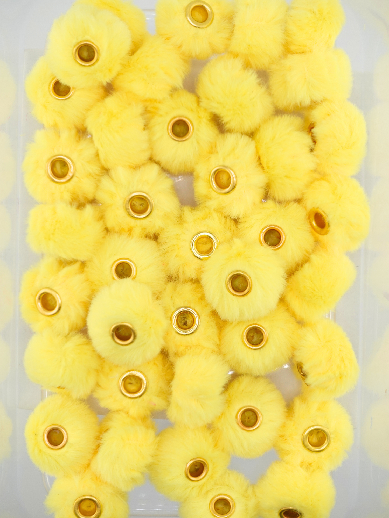 Collection of yellow fuzzy pom pom spacers