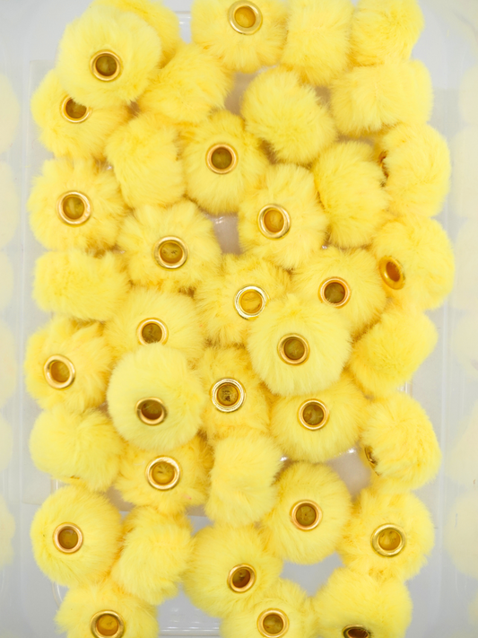 Collection of yellow fuzzy pom pom spacers